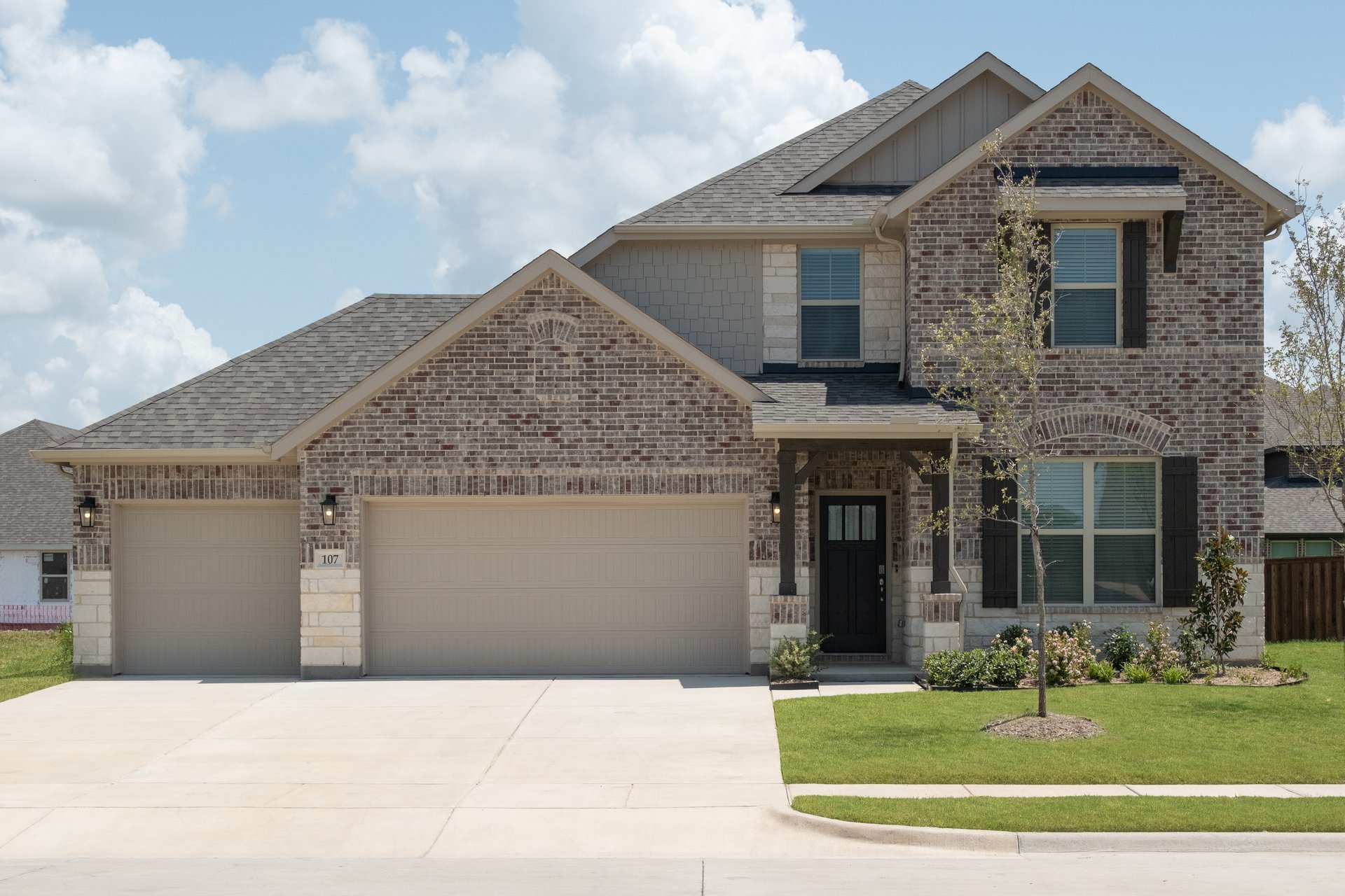 two-story home with brick and stone exterior