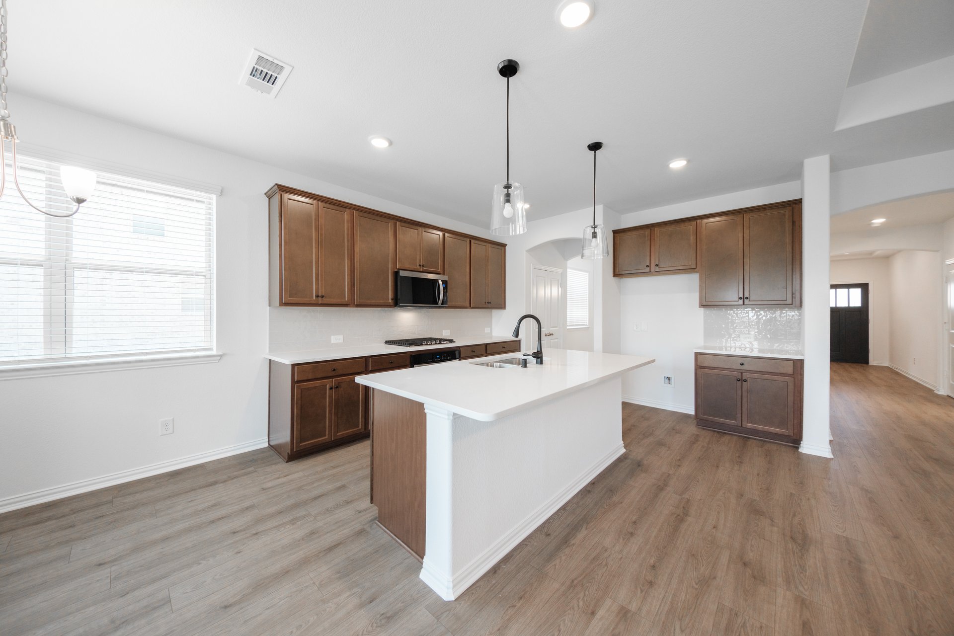 open kitchen with wood floors and island
