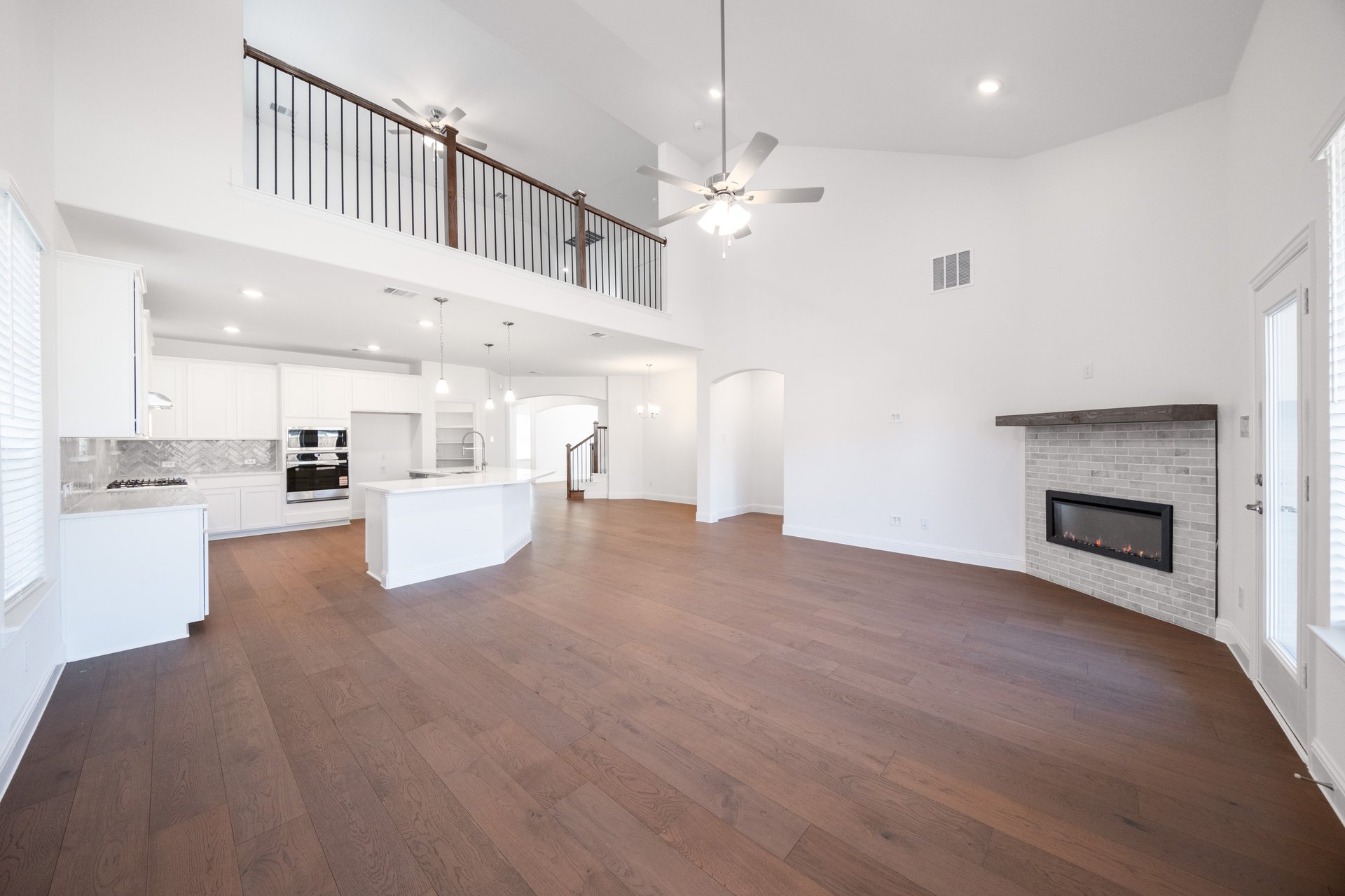 great room with wood flooring and fireplace