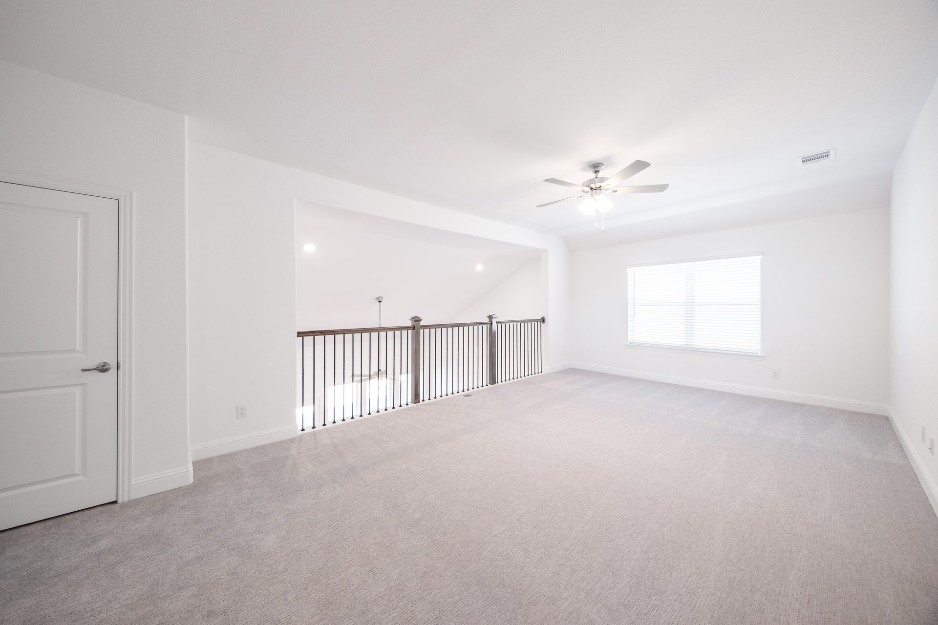 loft with carpet and window with bliinds