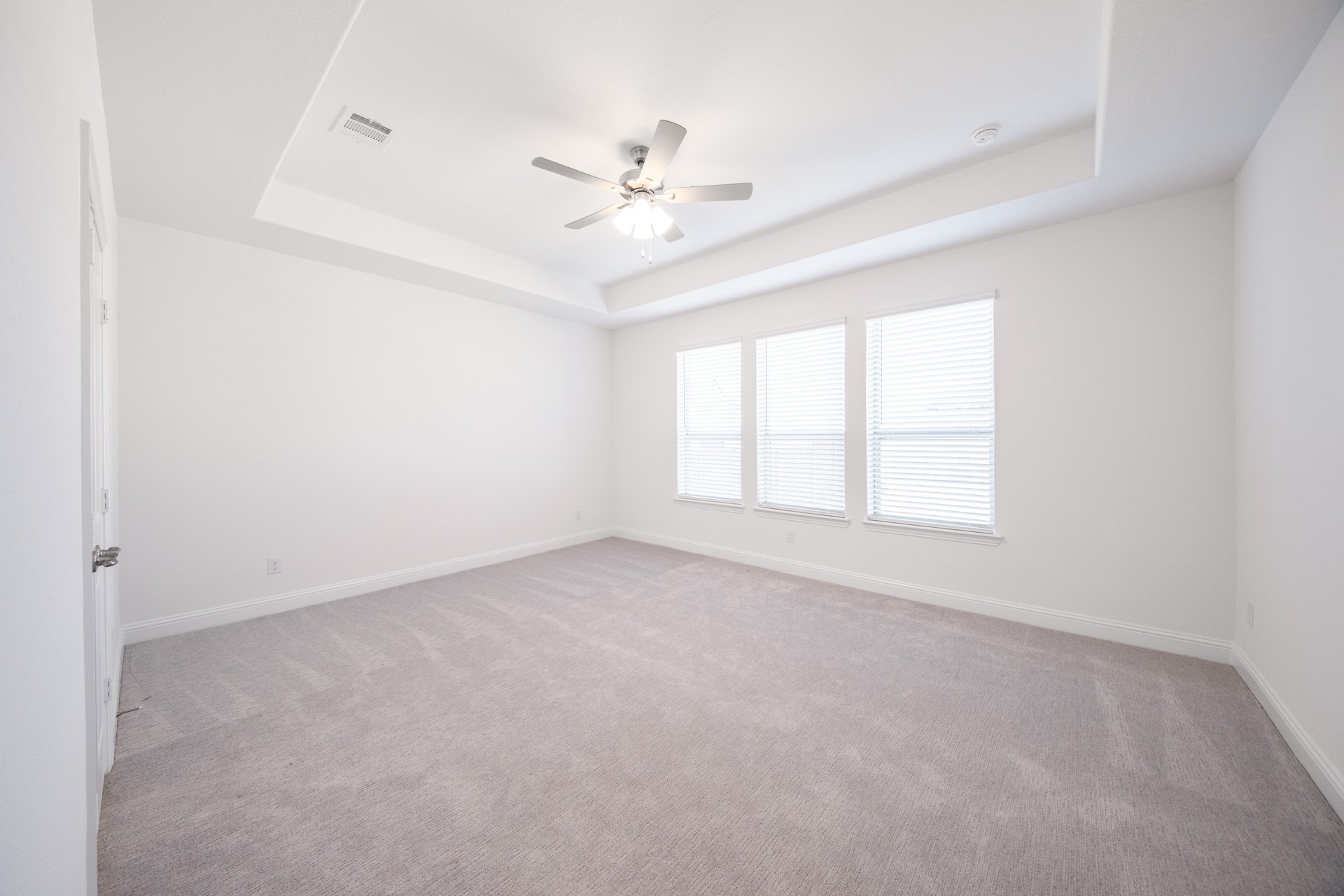 bedroom with carpet and windows with blinds 