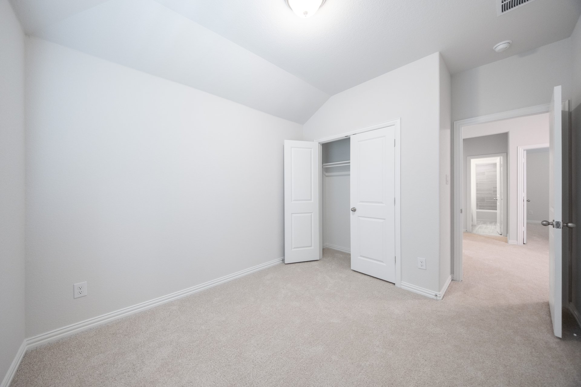 guest bedroom with carpet and walk-in closet