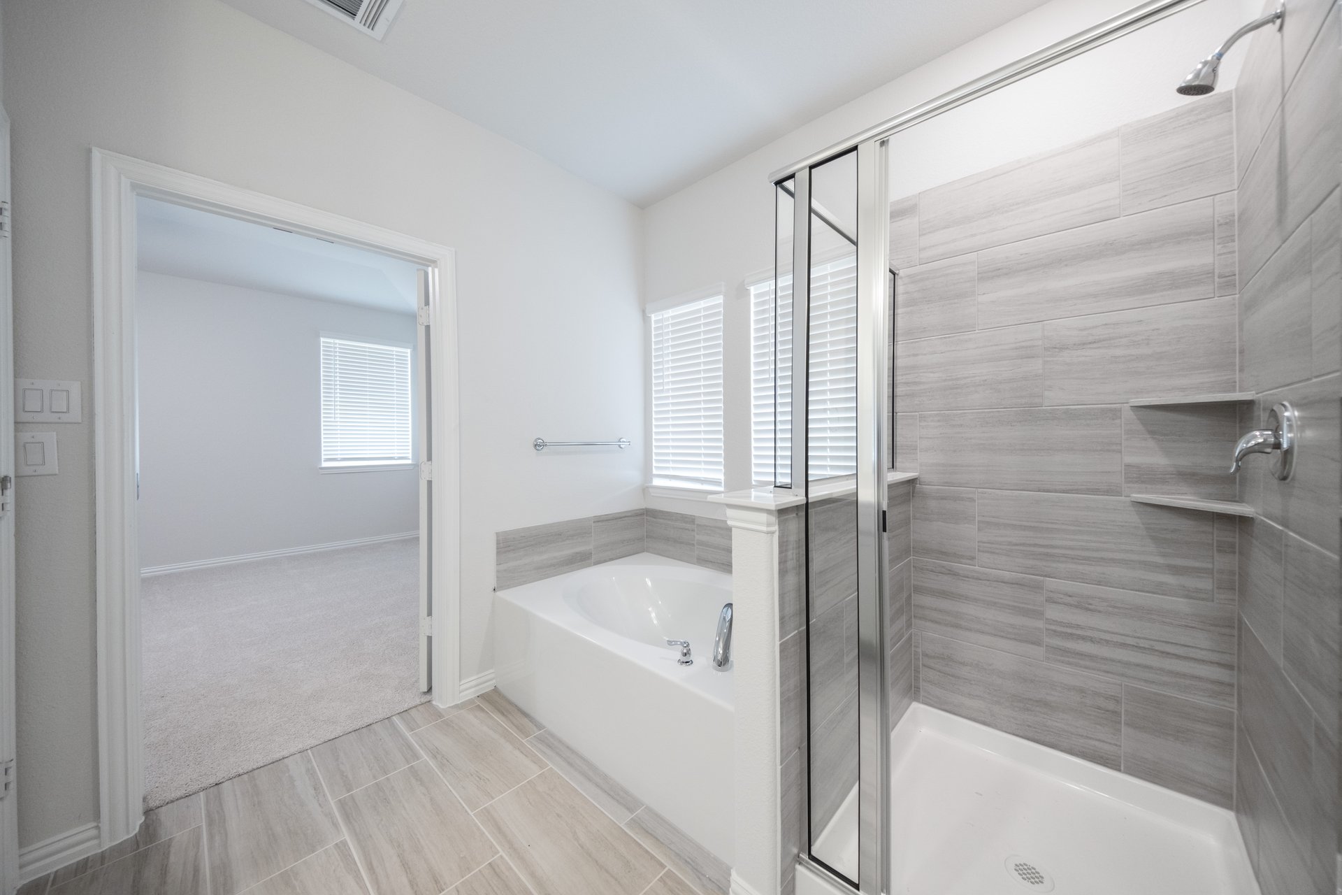 primary bathroom with separate tub and shower