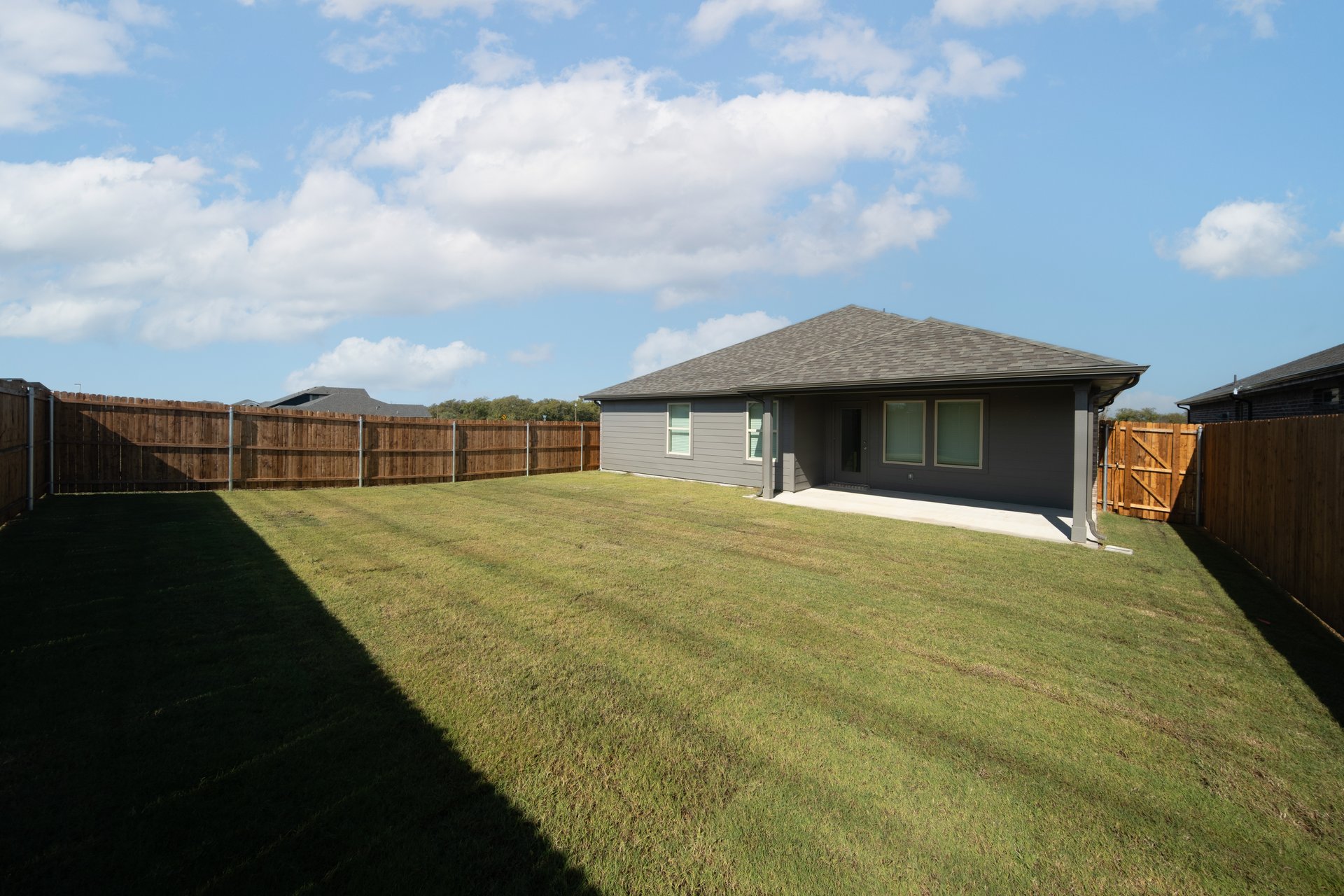 backyard with grass and covered patio