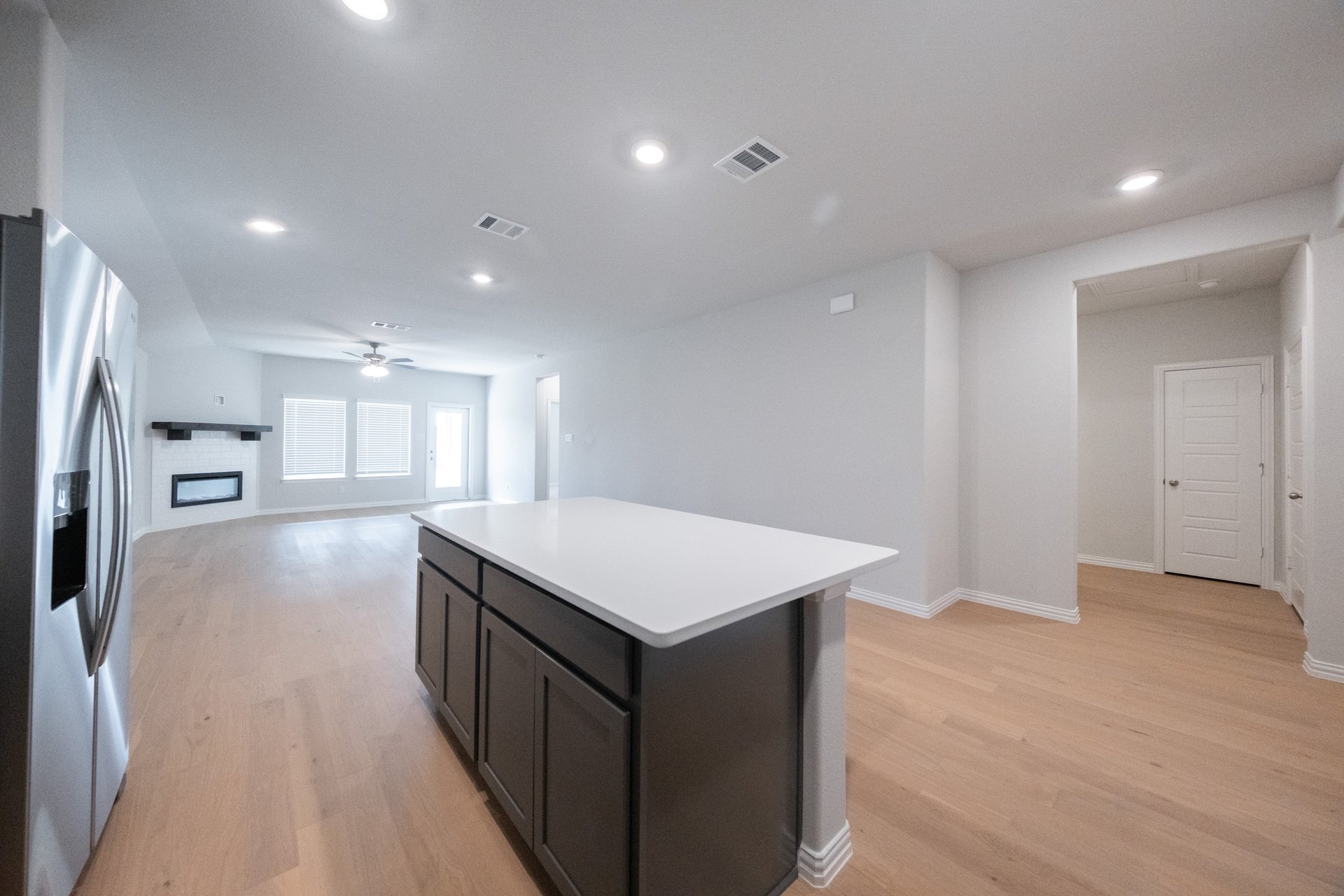open kitchen with wood floors and gray cabinets