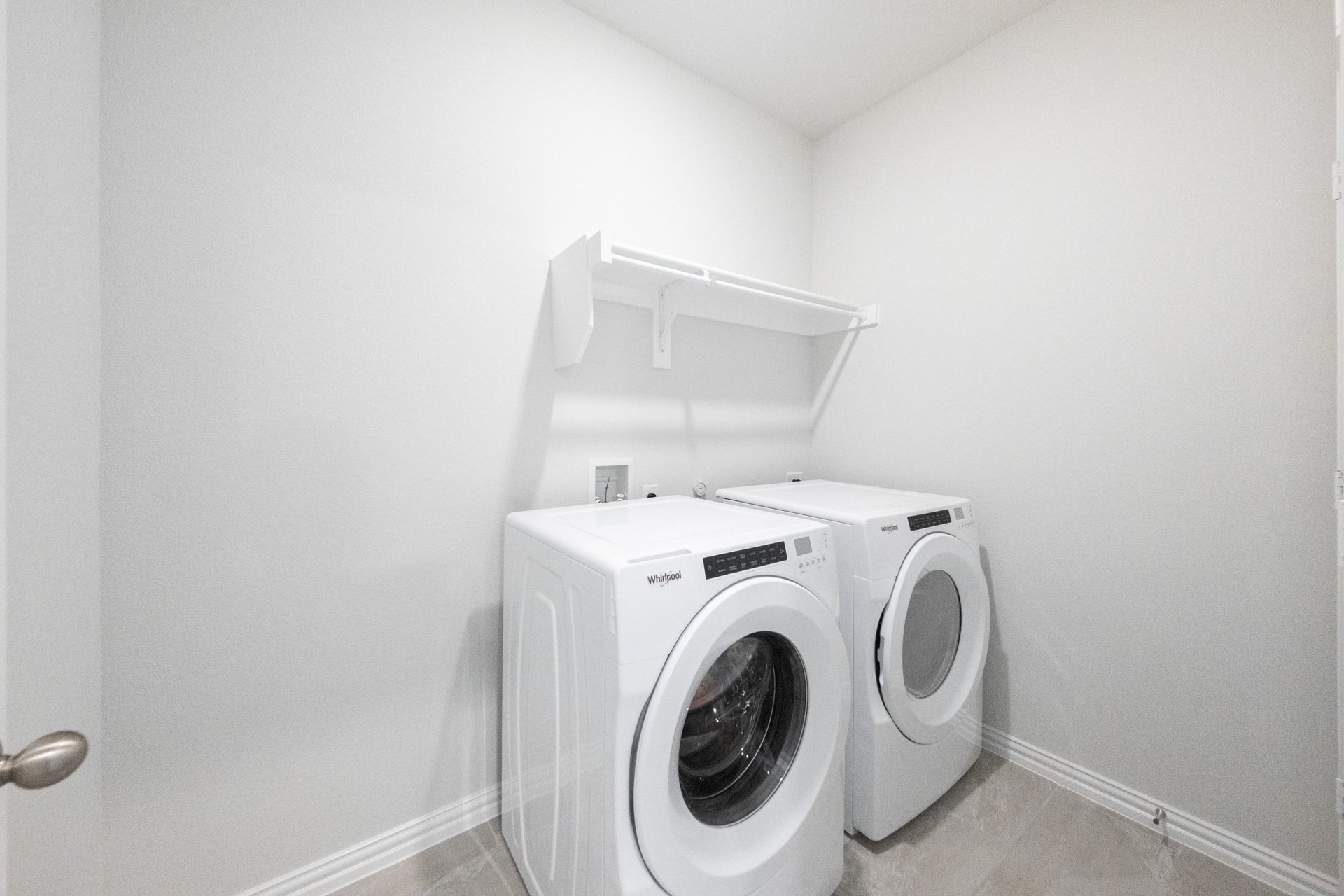 laundry room with tile floors, washer, and dryer
