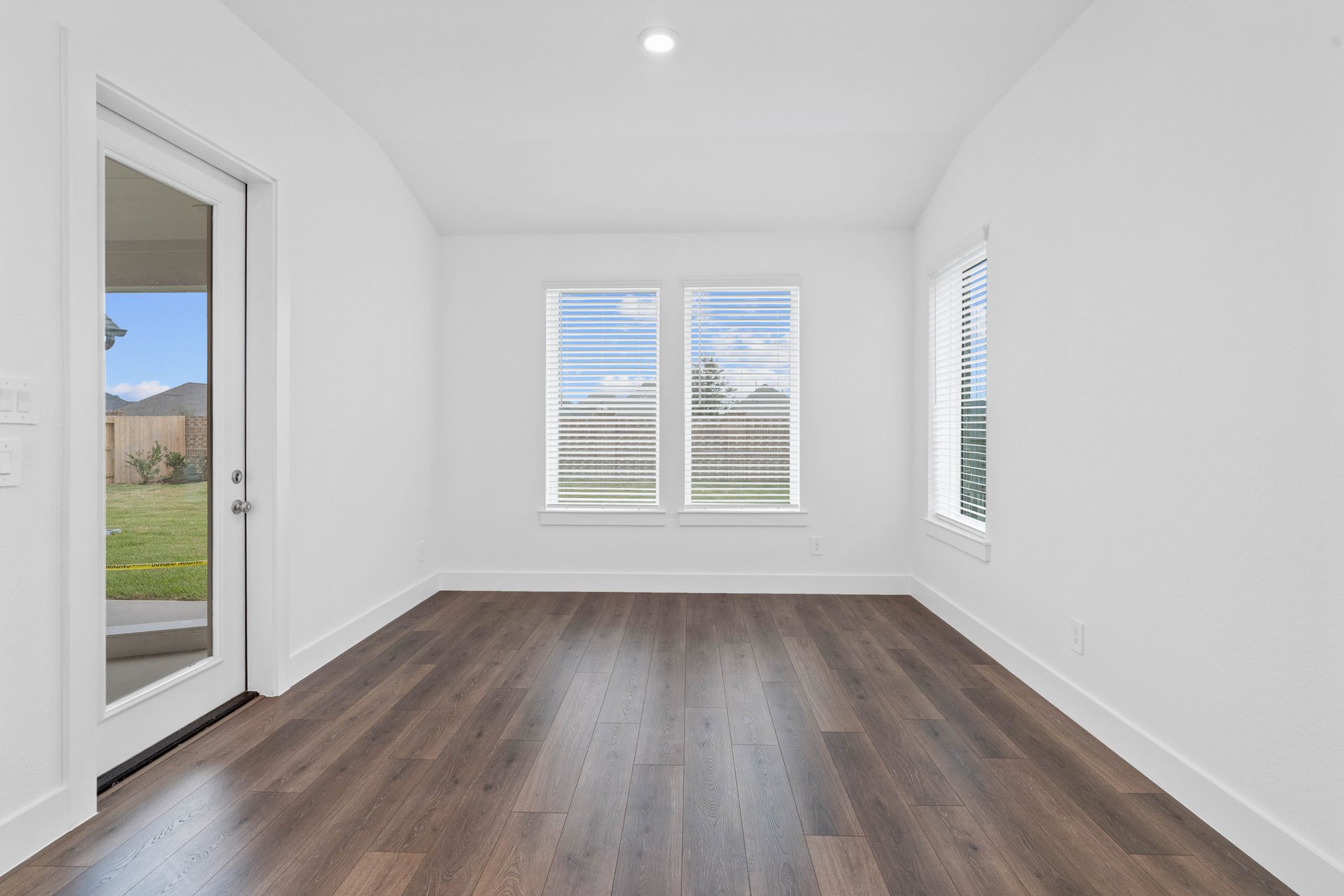 dining room with three windows and a patio door
