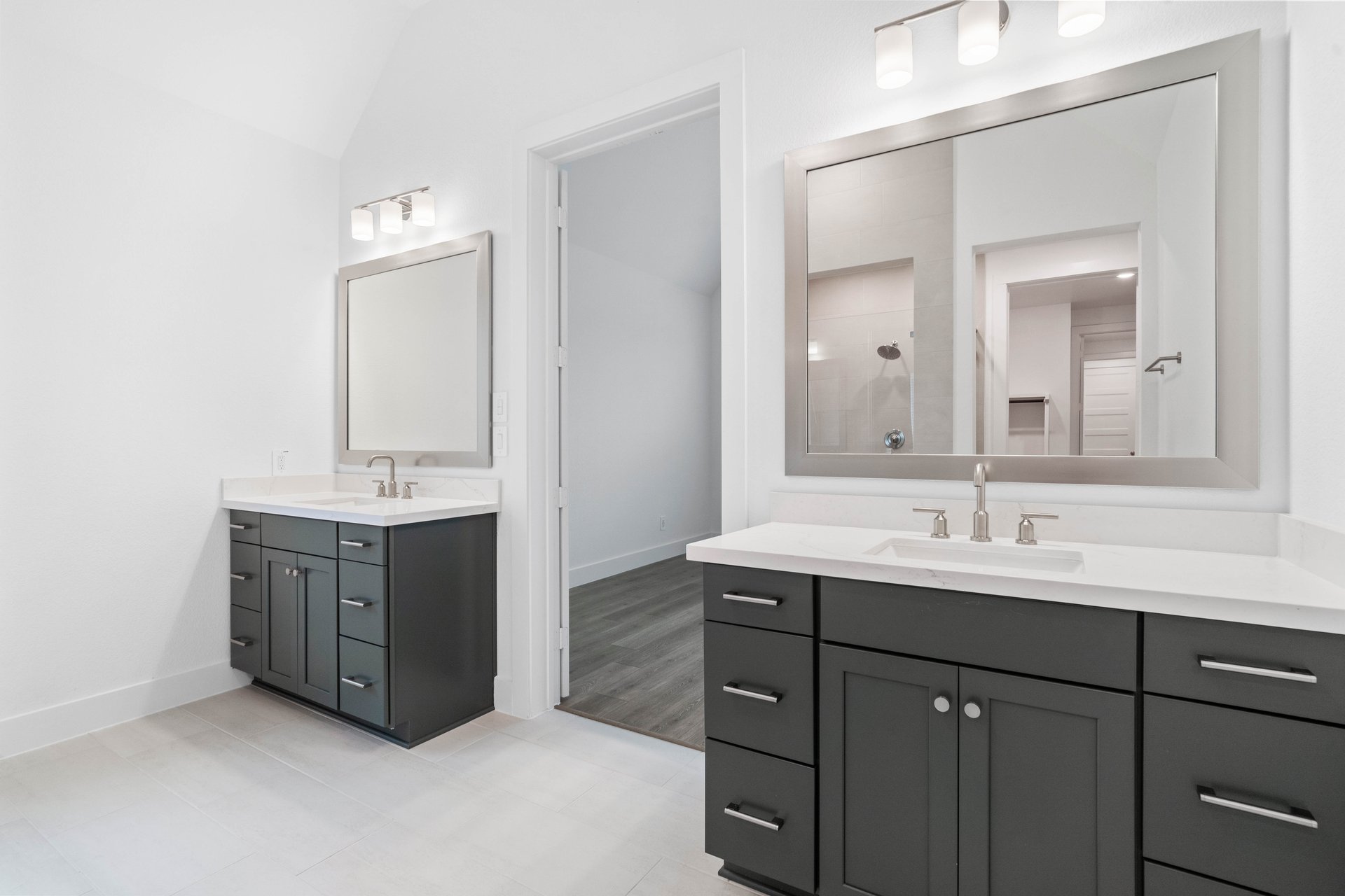 primary bathroom with two vanity sinks