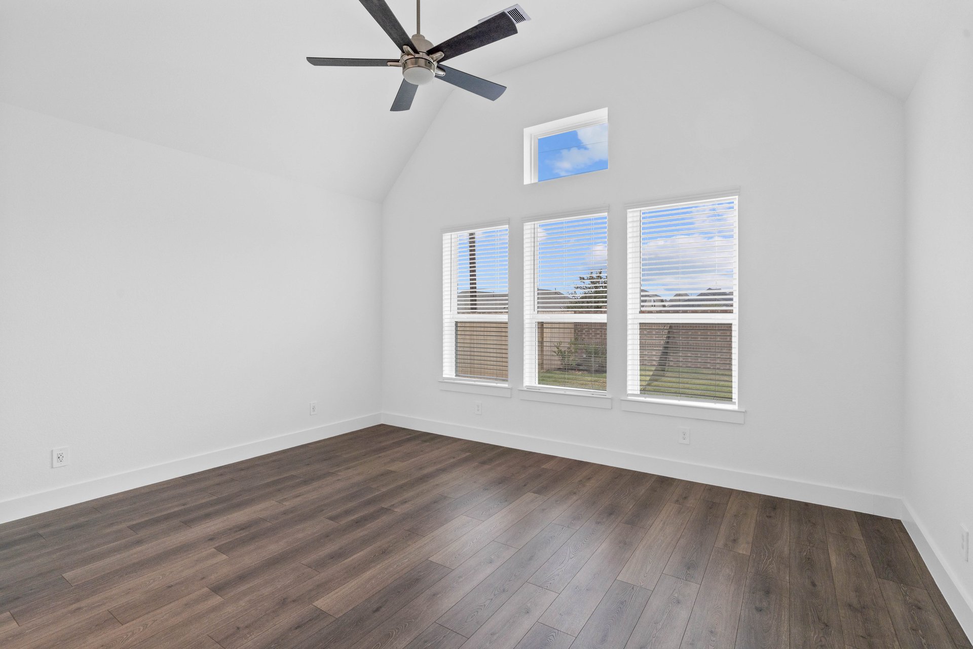 primary bedroom with wood-like flooring