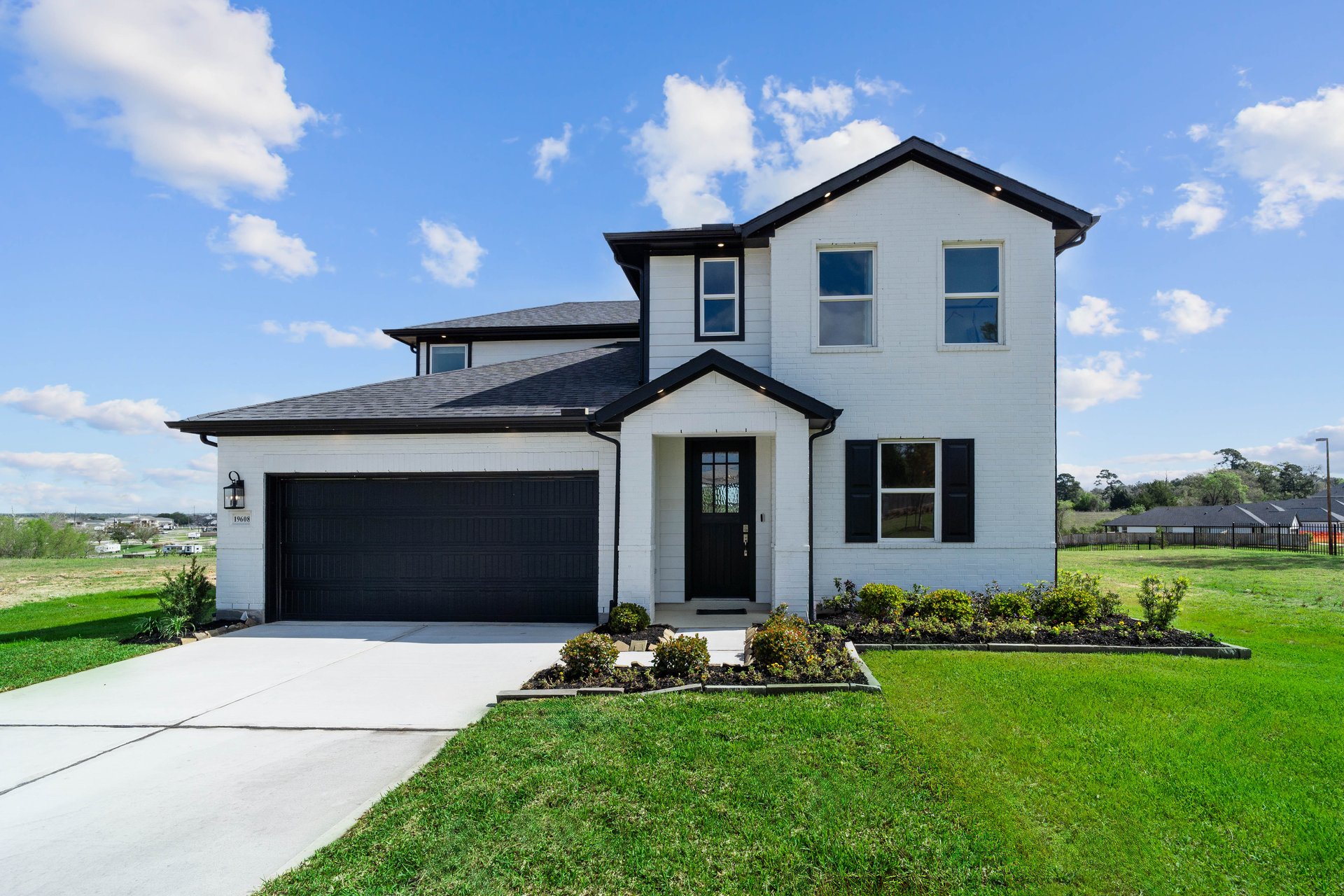 exterior of home with white brick and black siding