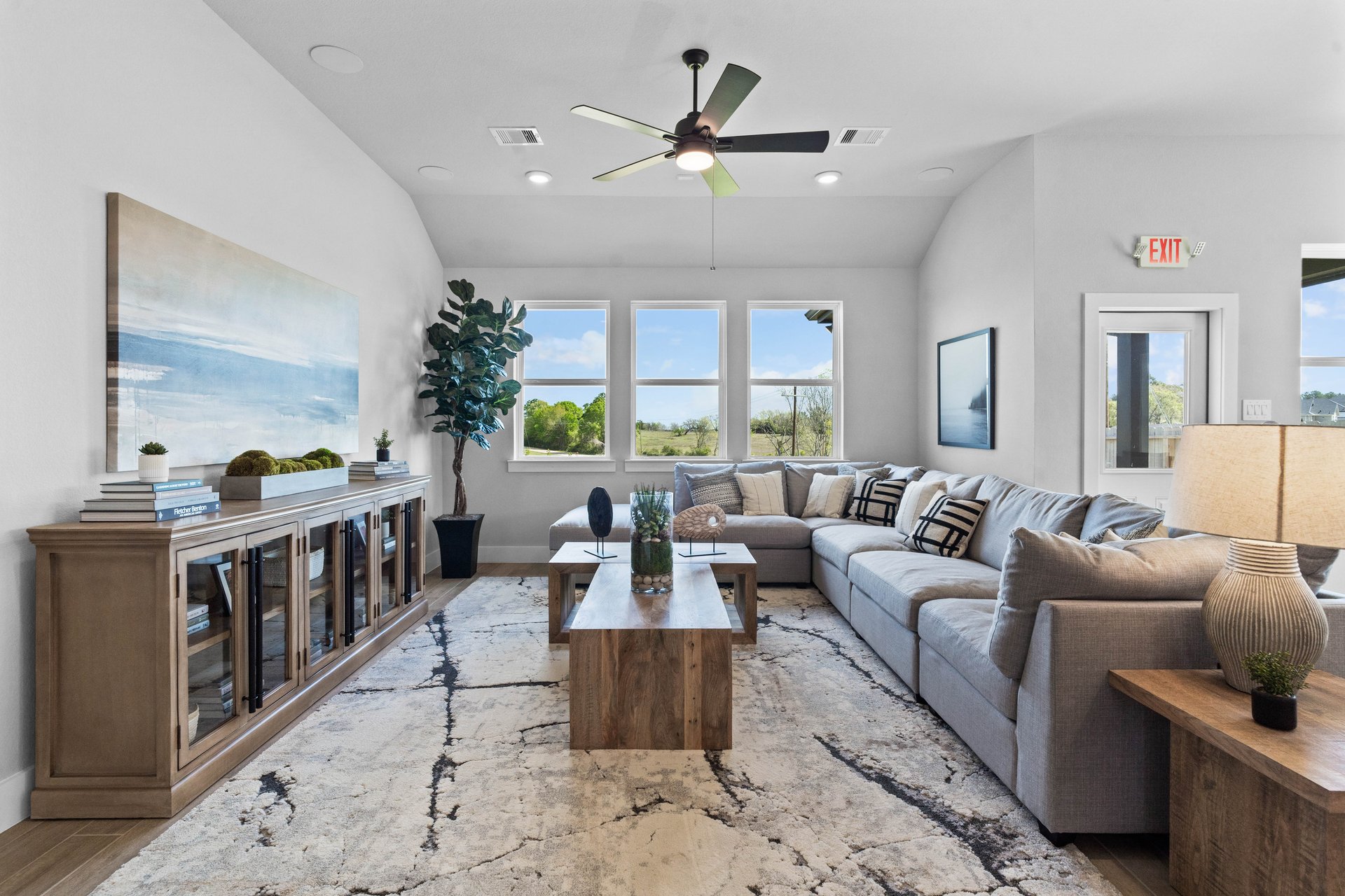 open great room with hardwood flooring and windows