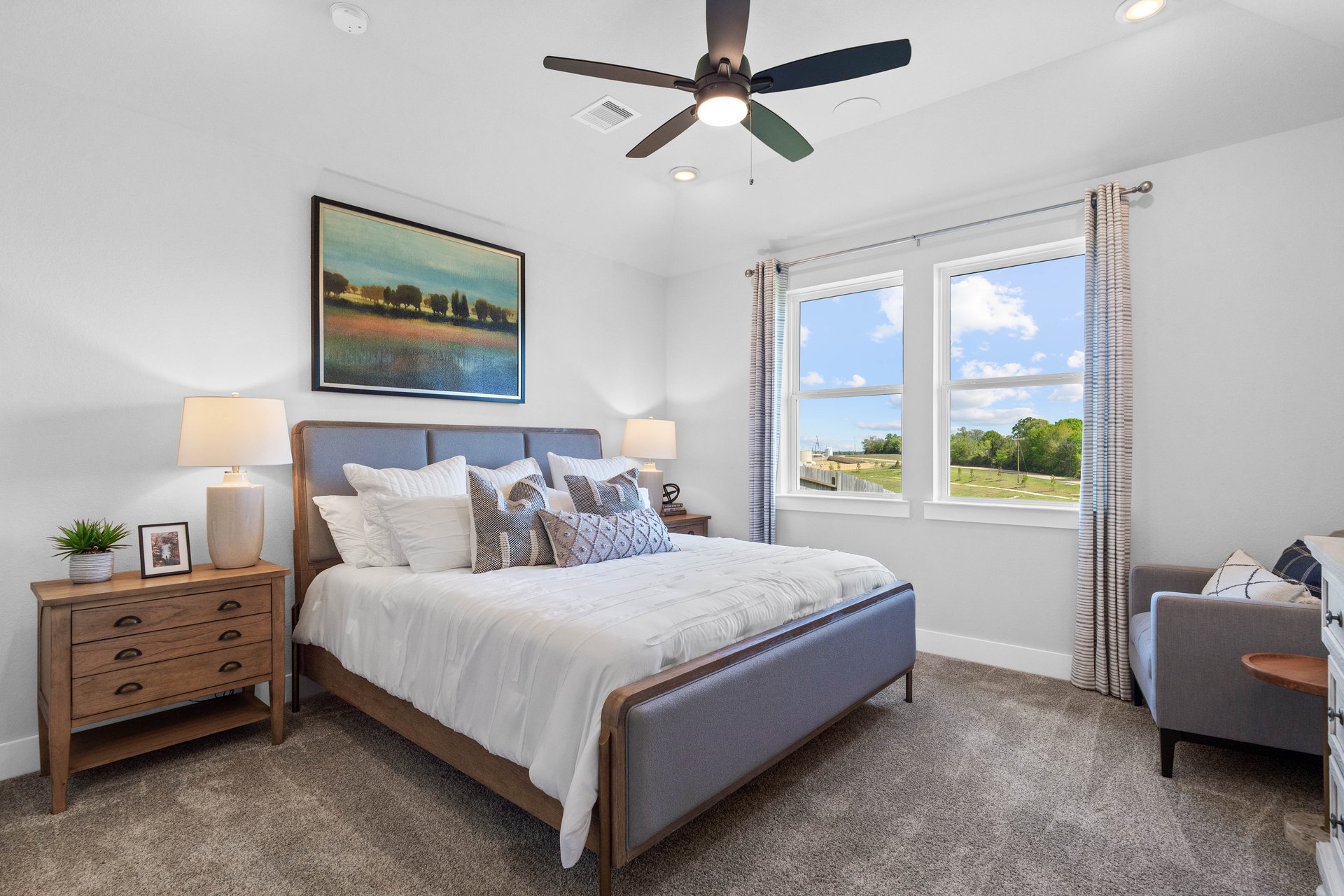 primary bedroom with carpet and ceiling fan