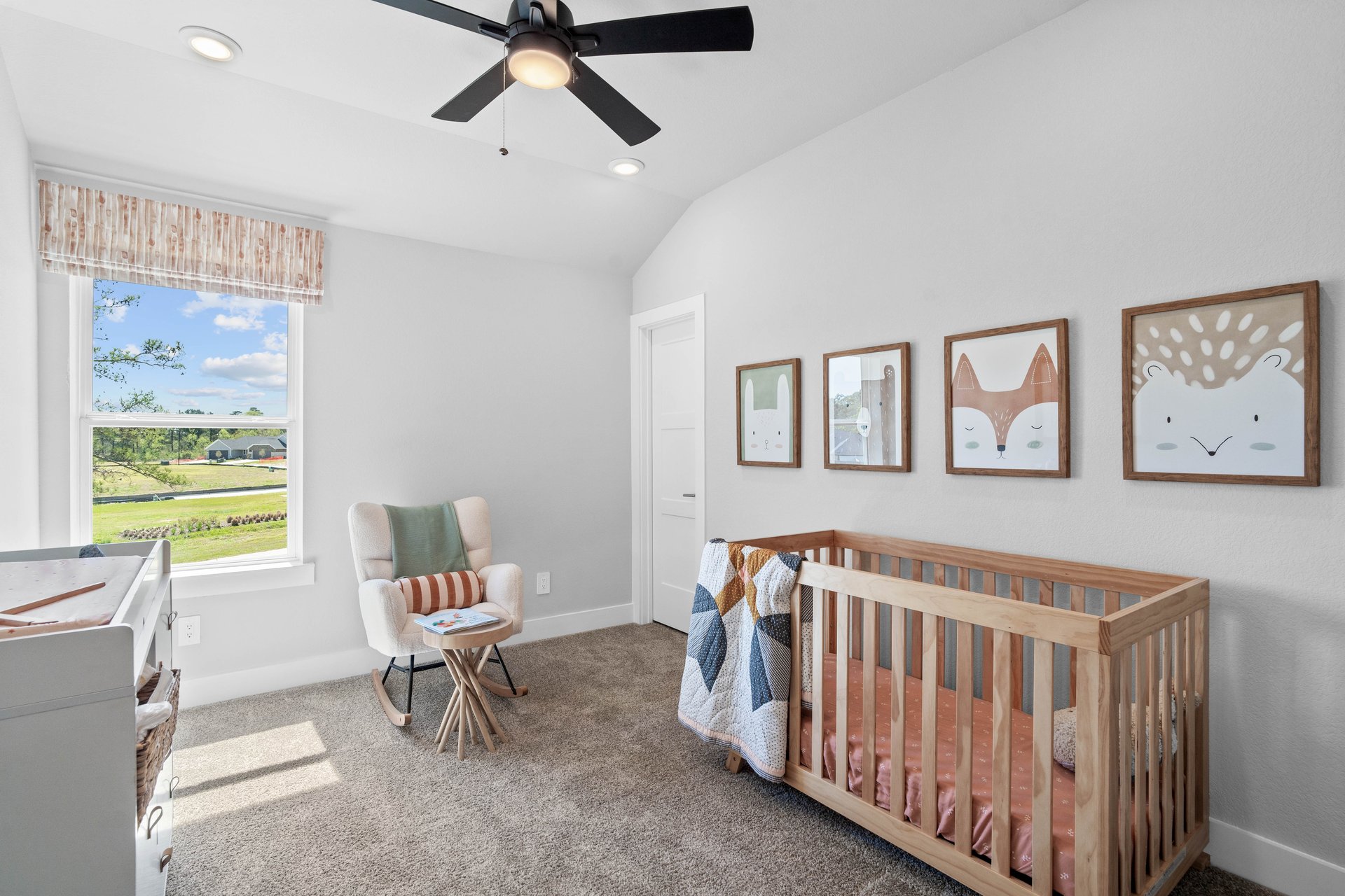 guest bedroom with window and carpet