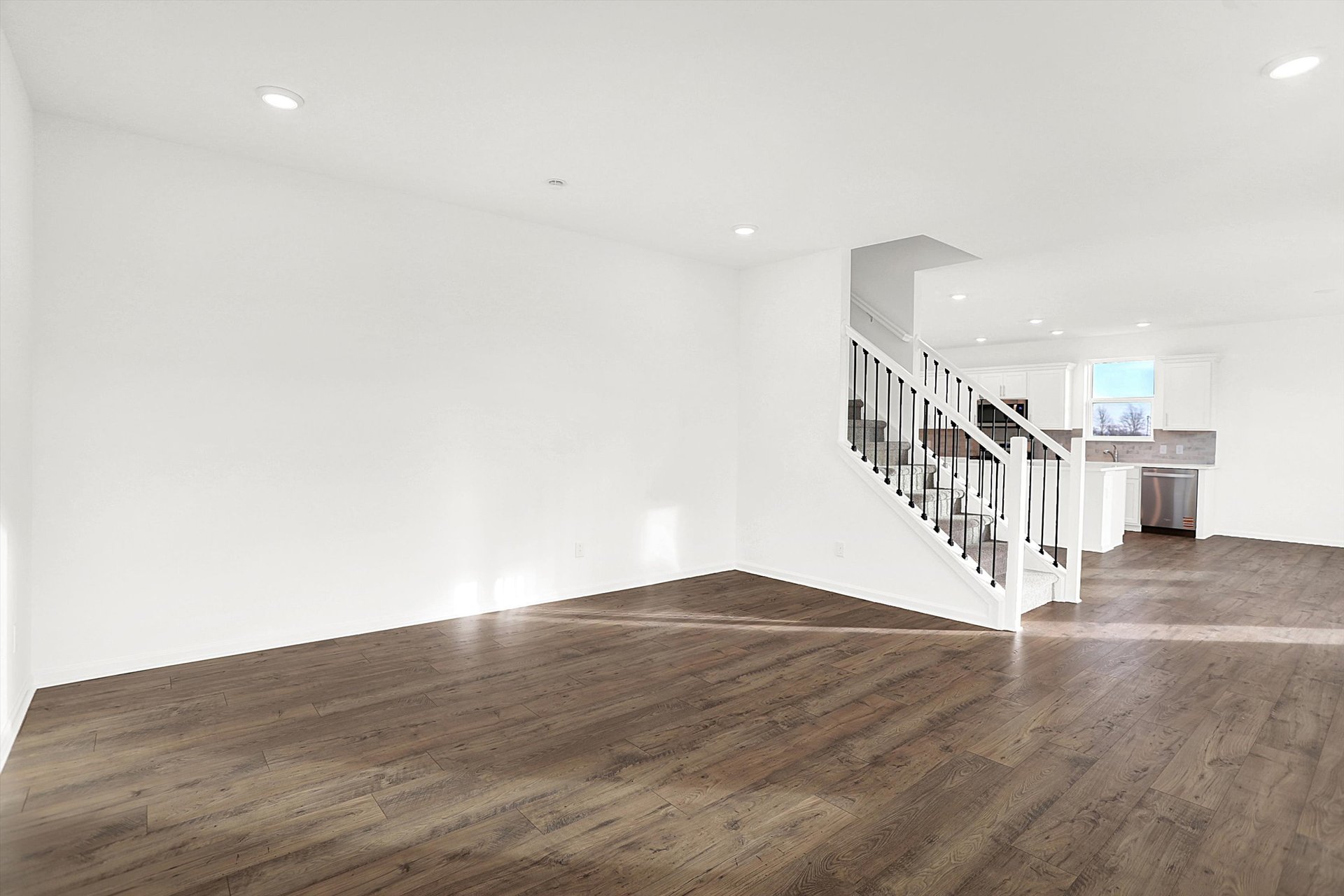 great room with wood plank flooring and stair case