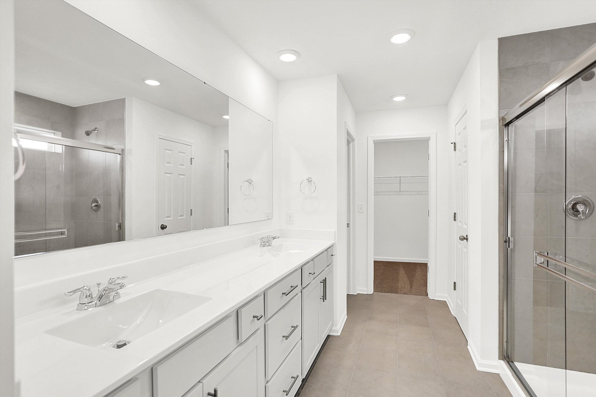 bathroom with dual sink vanity and tile floor