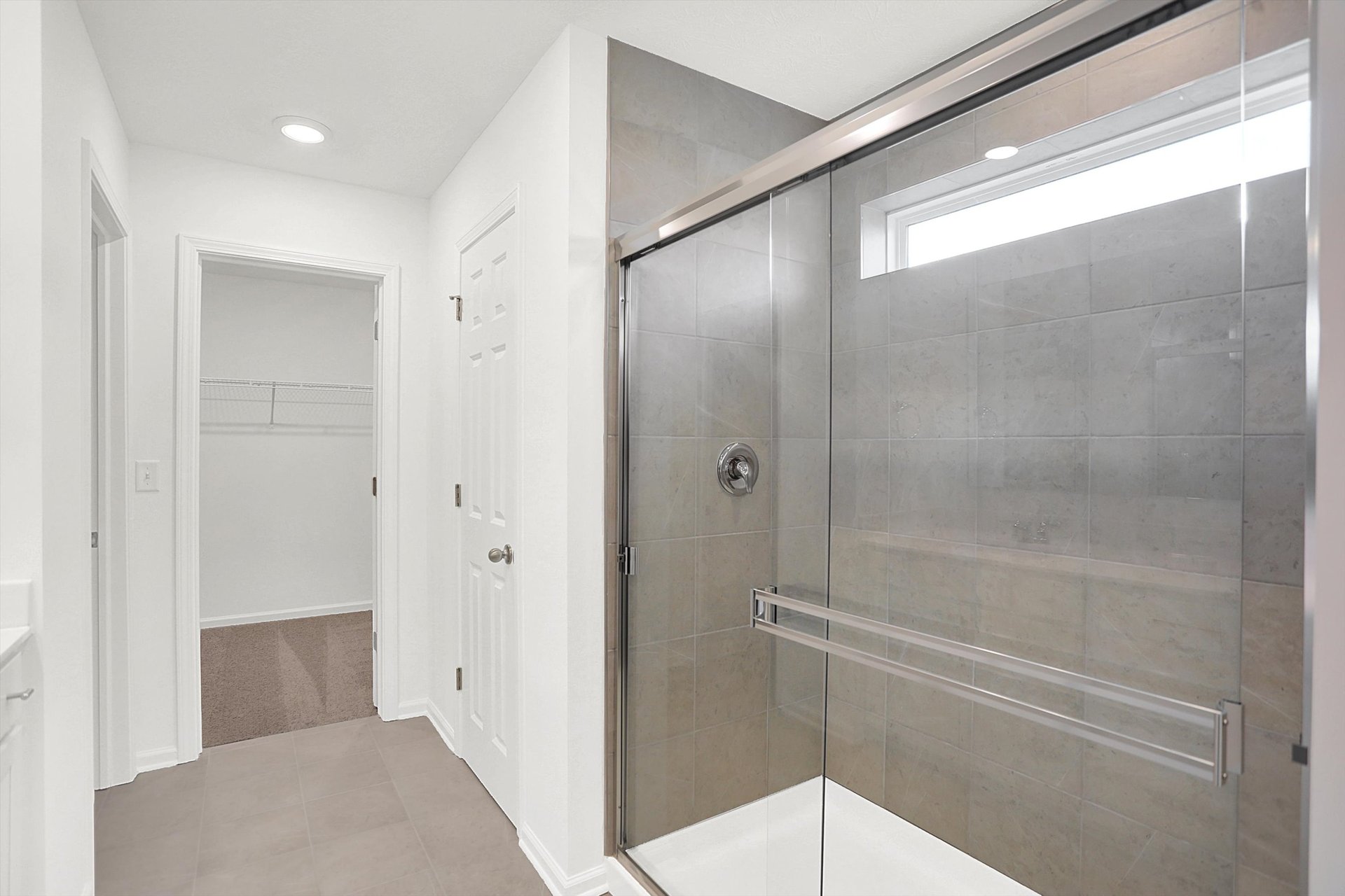 bathroom with tile walk-in shower