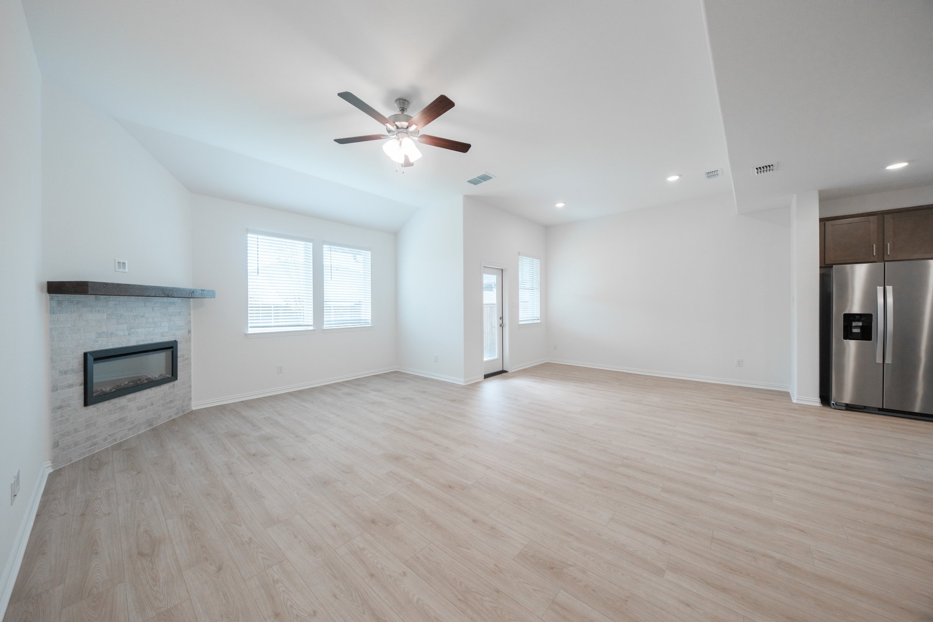 open great room with wood floors and fireplace