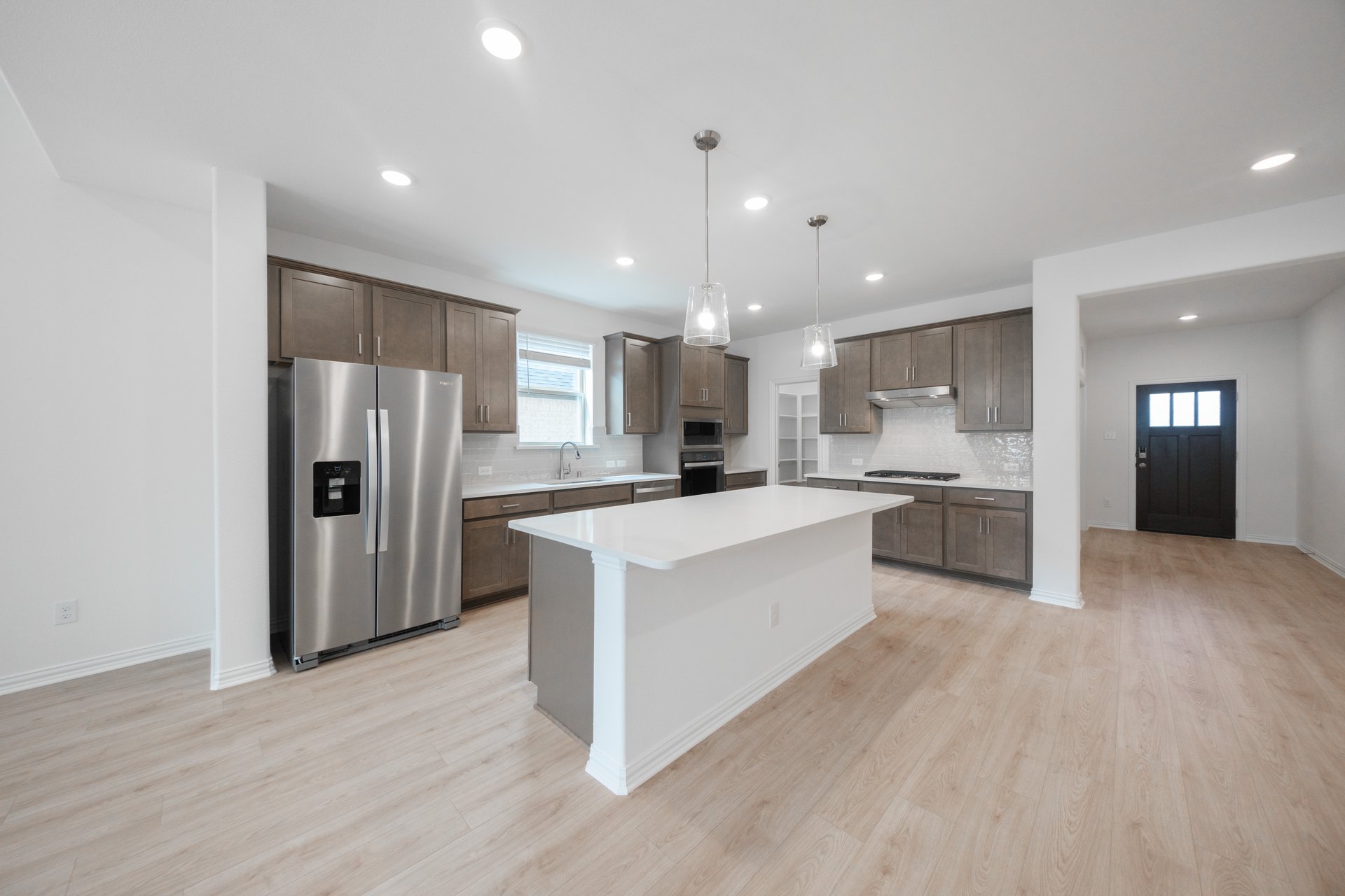 open kitchen with wood floors and island