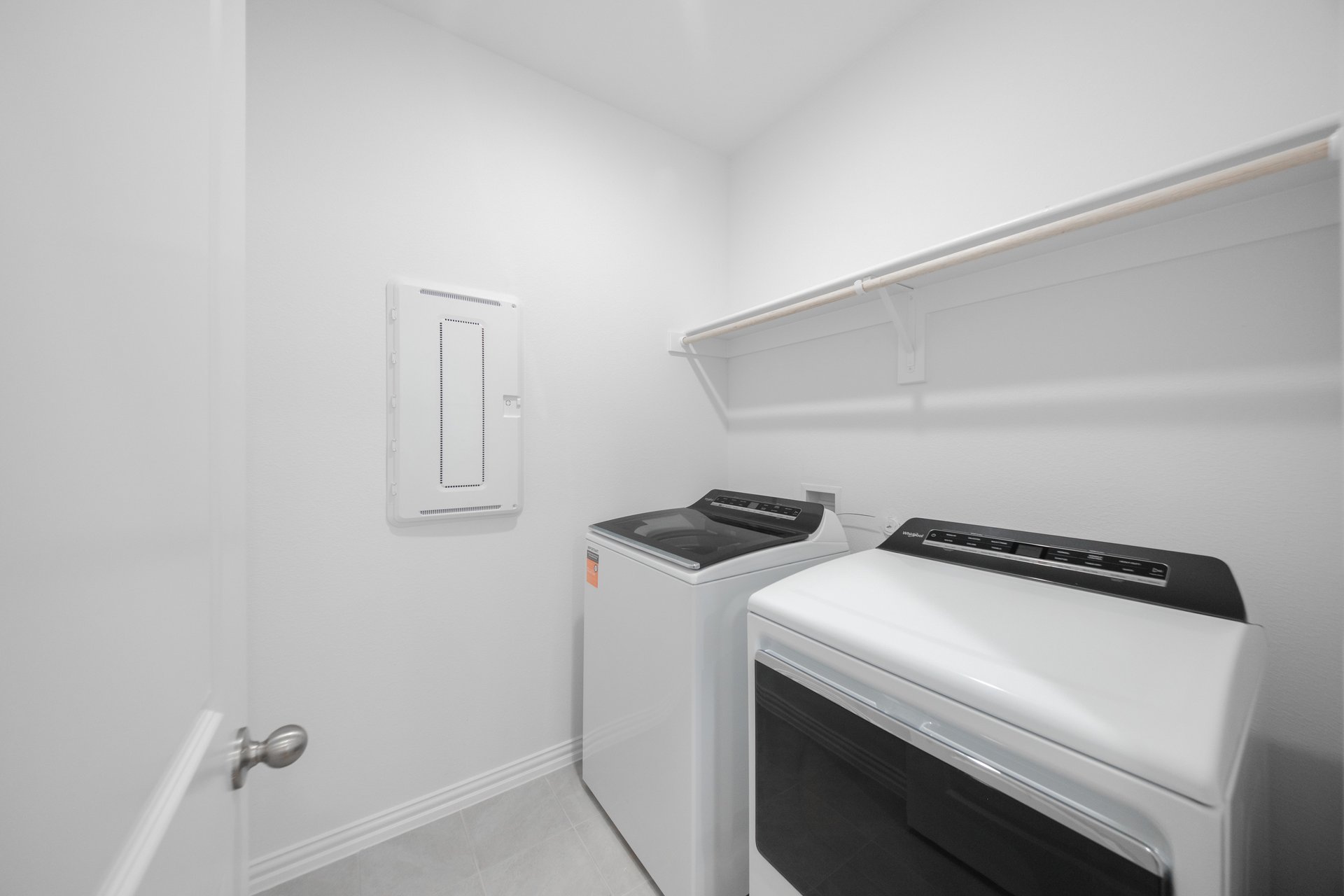 laundry room with tile floors, washer, and dryer