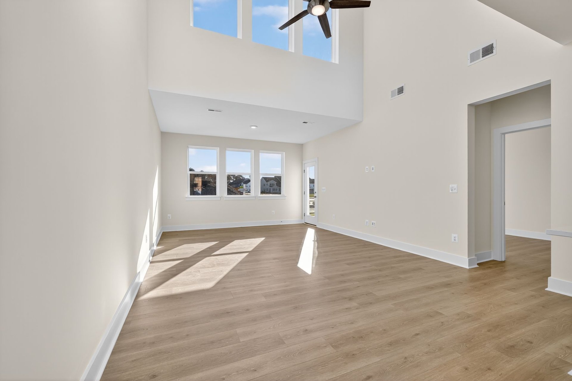 great room extends to the kitchen with access to the backyard