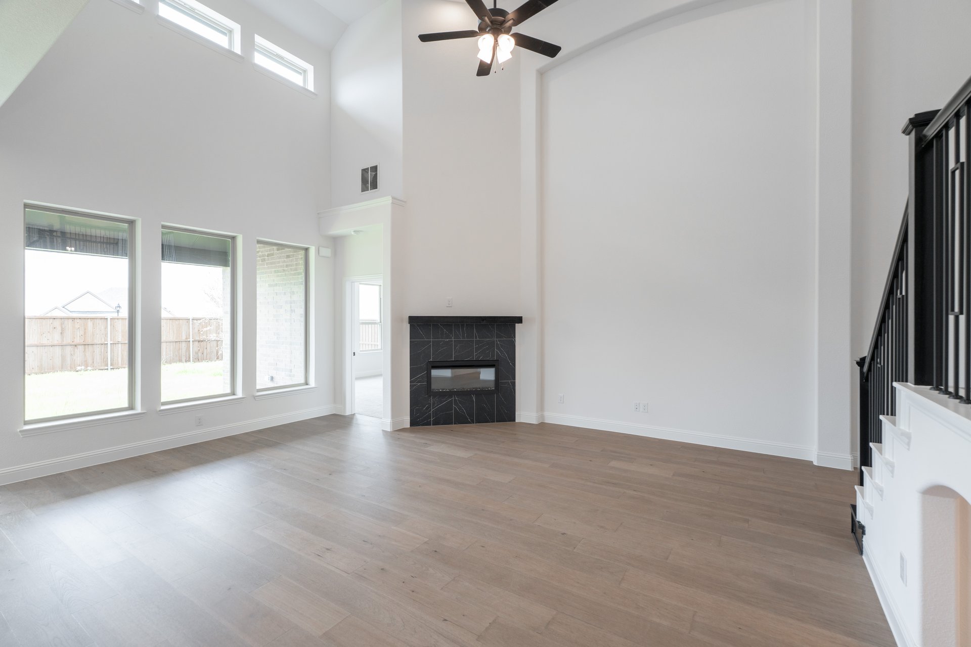 open great room with wood floors and fireplace