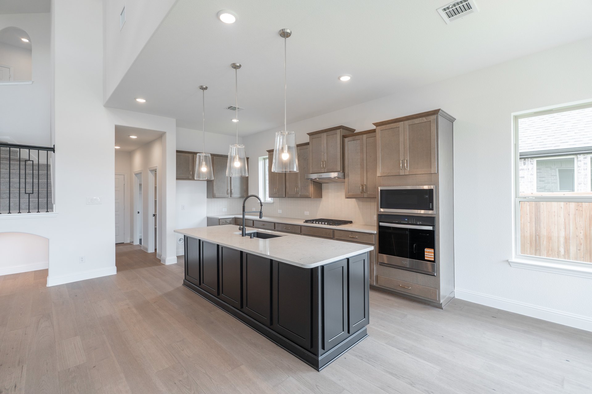 open kitchen with wood floors and island