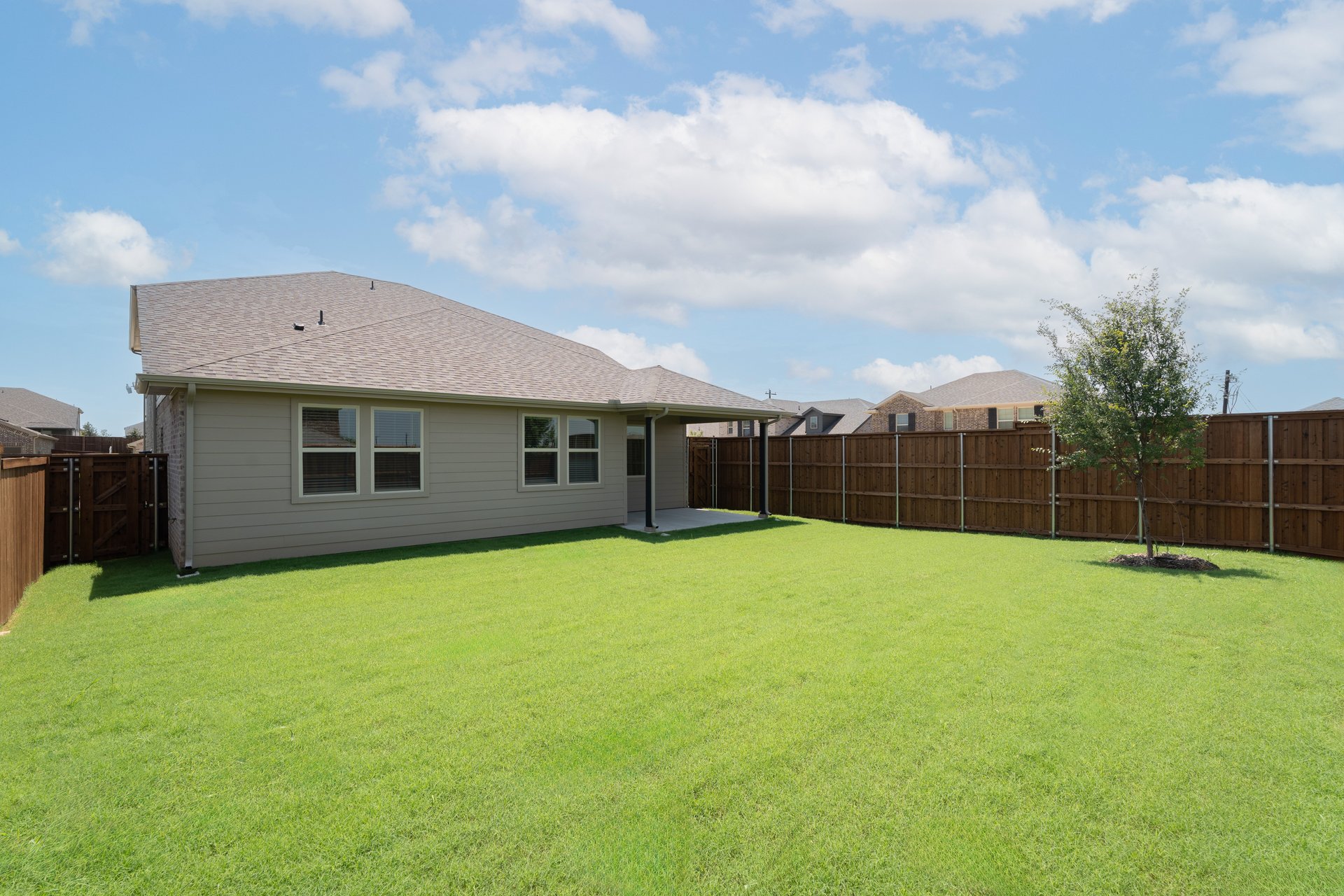 backyard with grass and covered patio