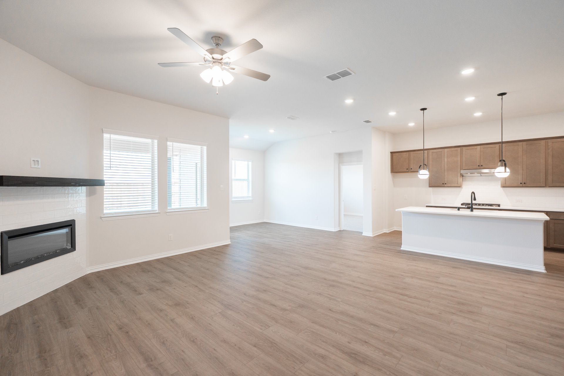 open great room with wood floors and fireplace
