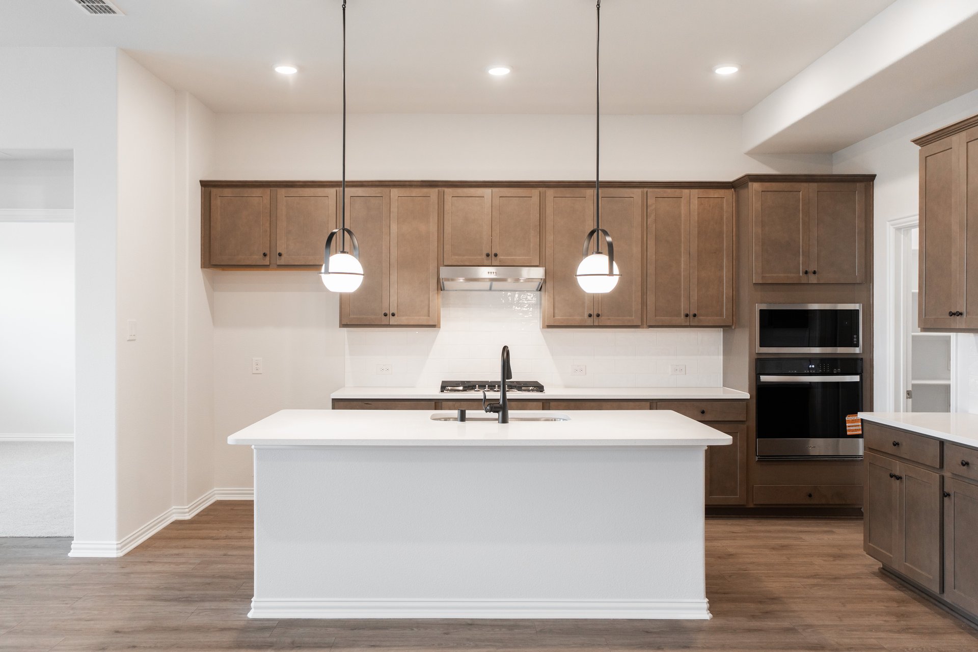 open kitchen with wood floors and island
