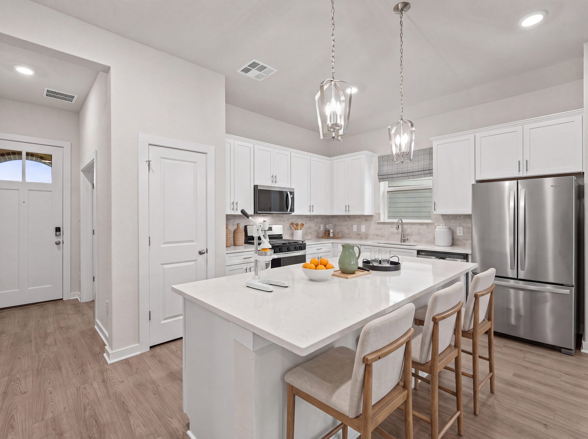 kitchen with quartz countertops, white cabinets and pendant lighting