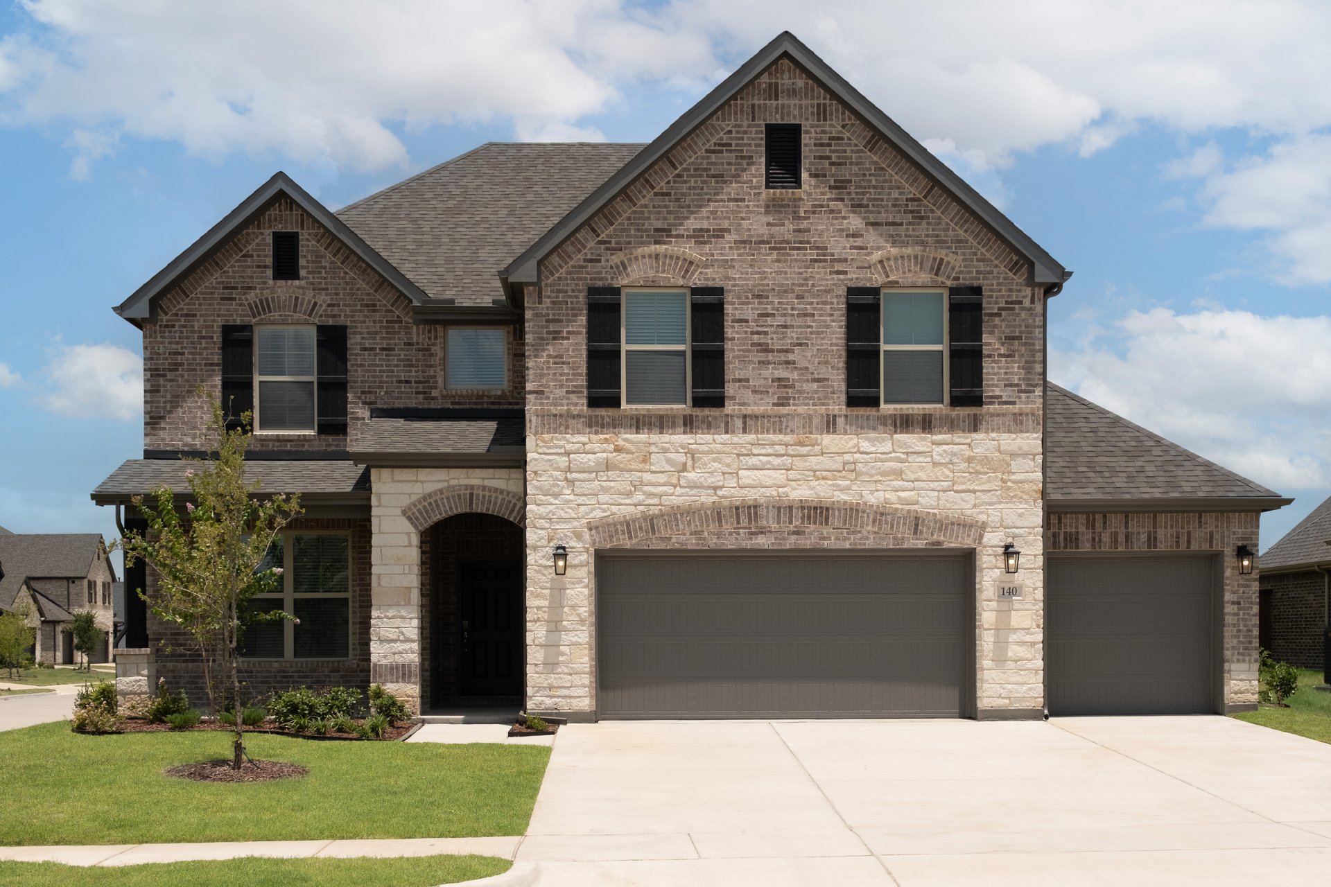 two-story home with brick and stone exterior