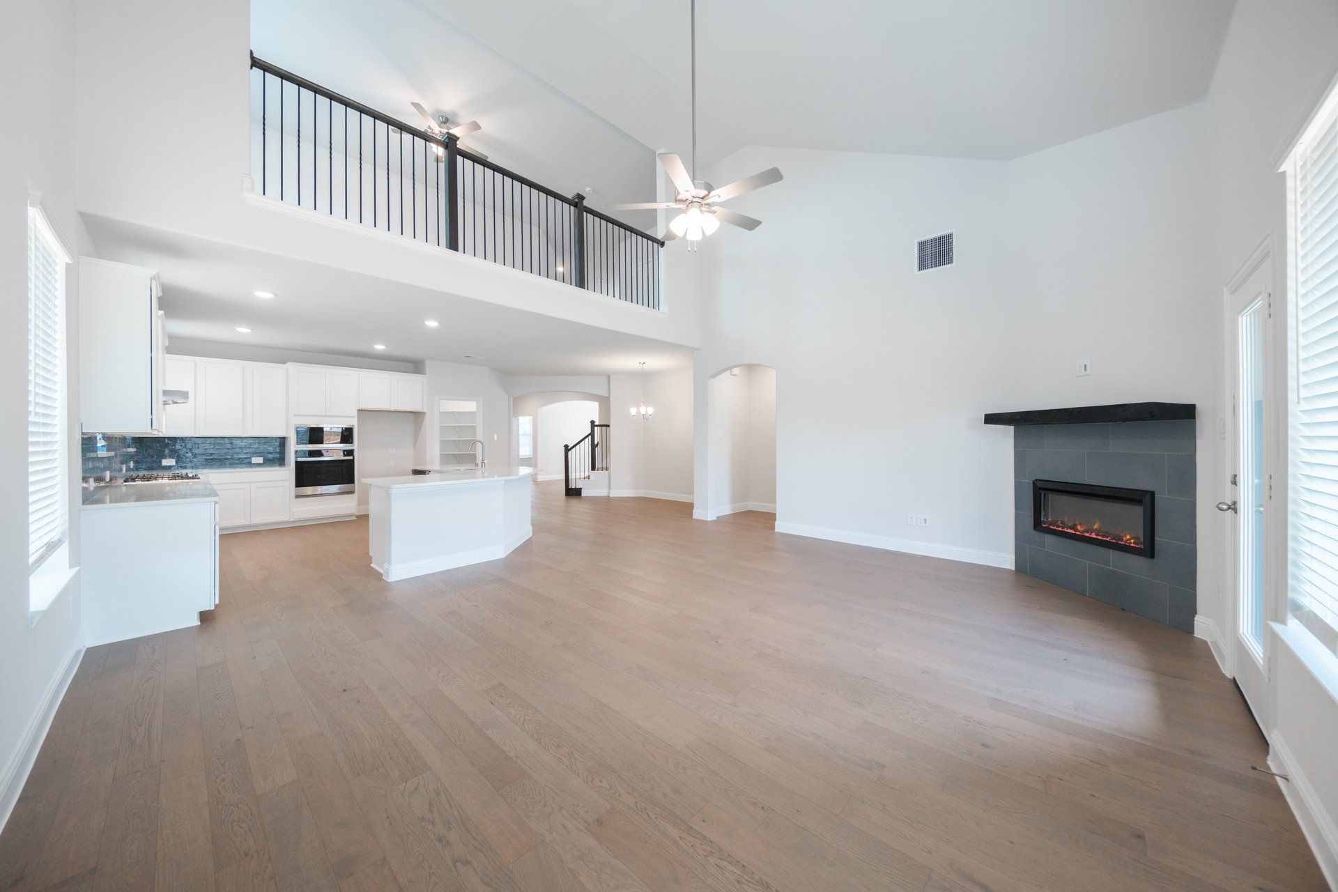 open great room with wood floors and fireplace