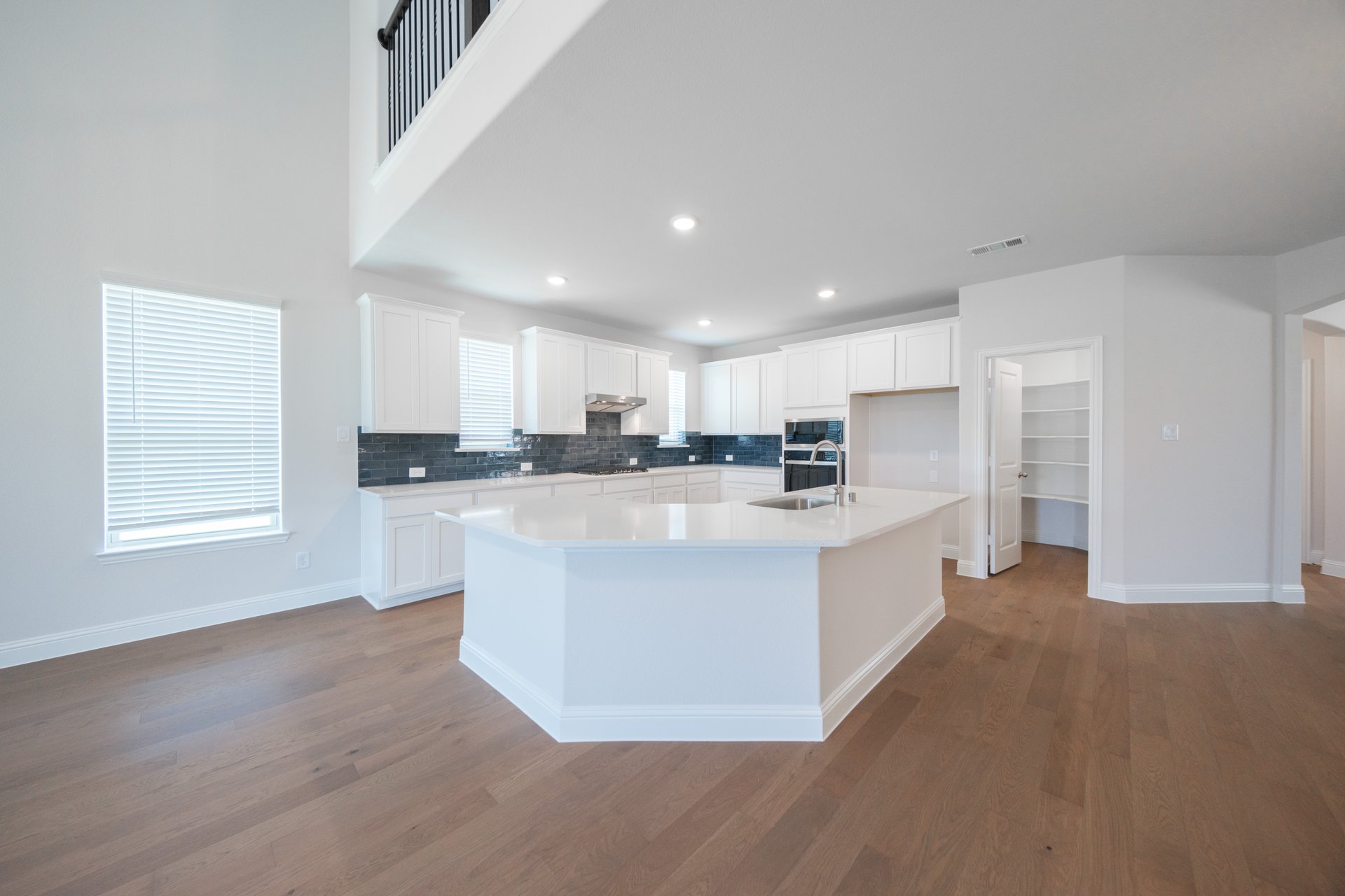  open kitchen with wood floors and island