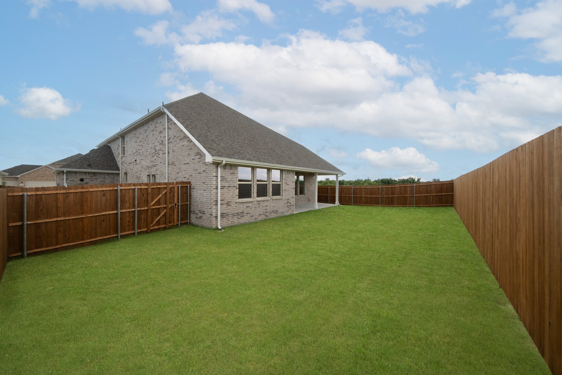 backyard with grass and covered patio