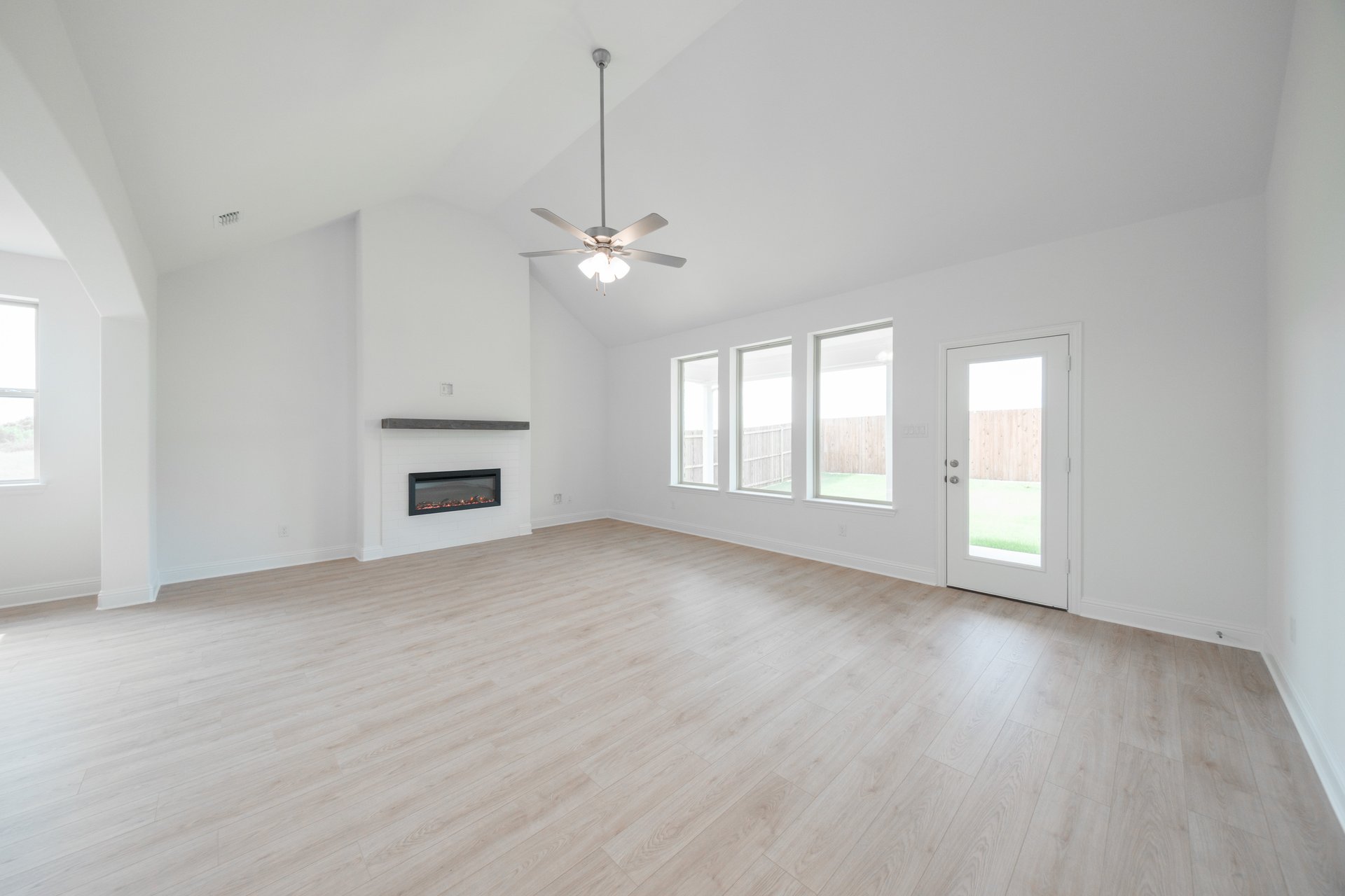 open great room with wood floors and fireplace