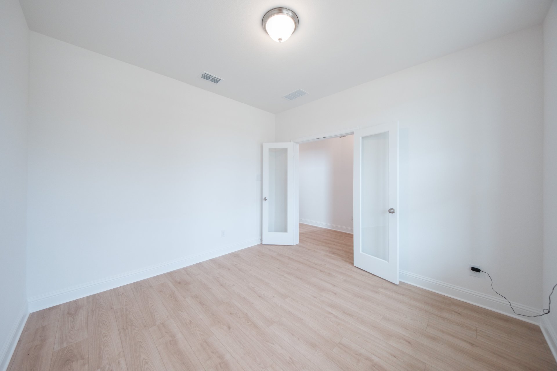 private study with wood floors and windows