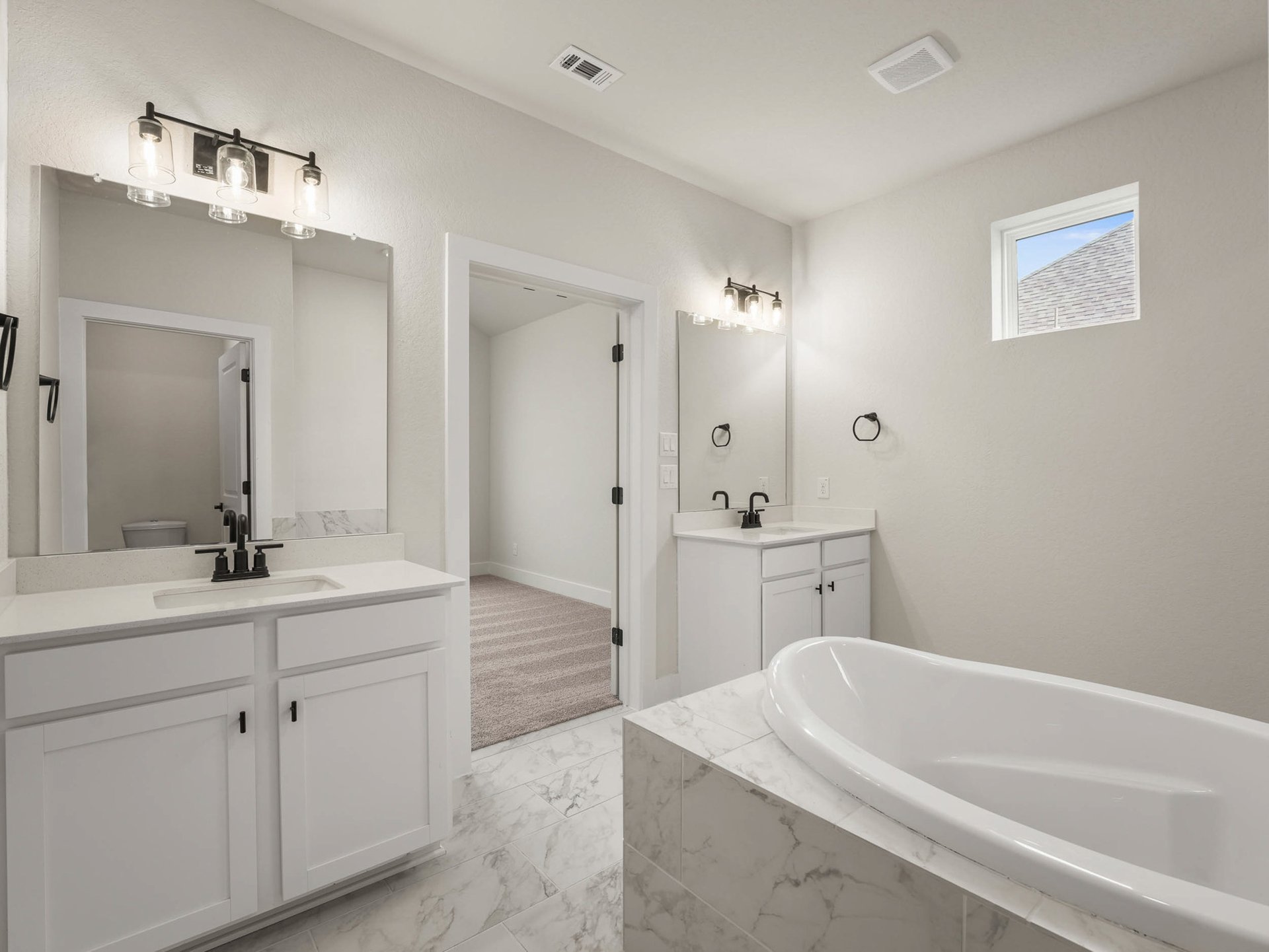 bath with two sinks, white floor and soaking tub
