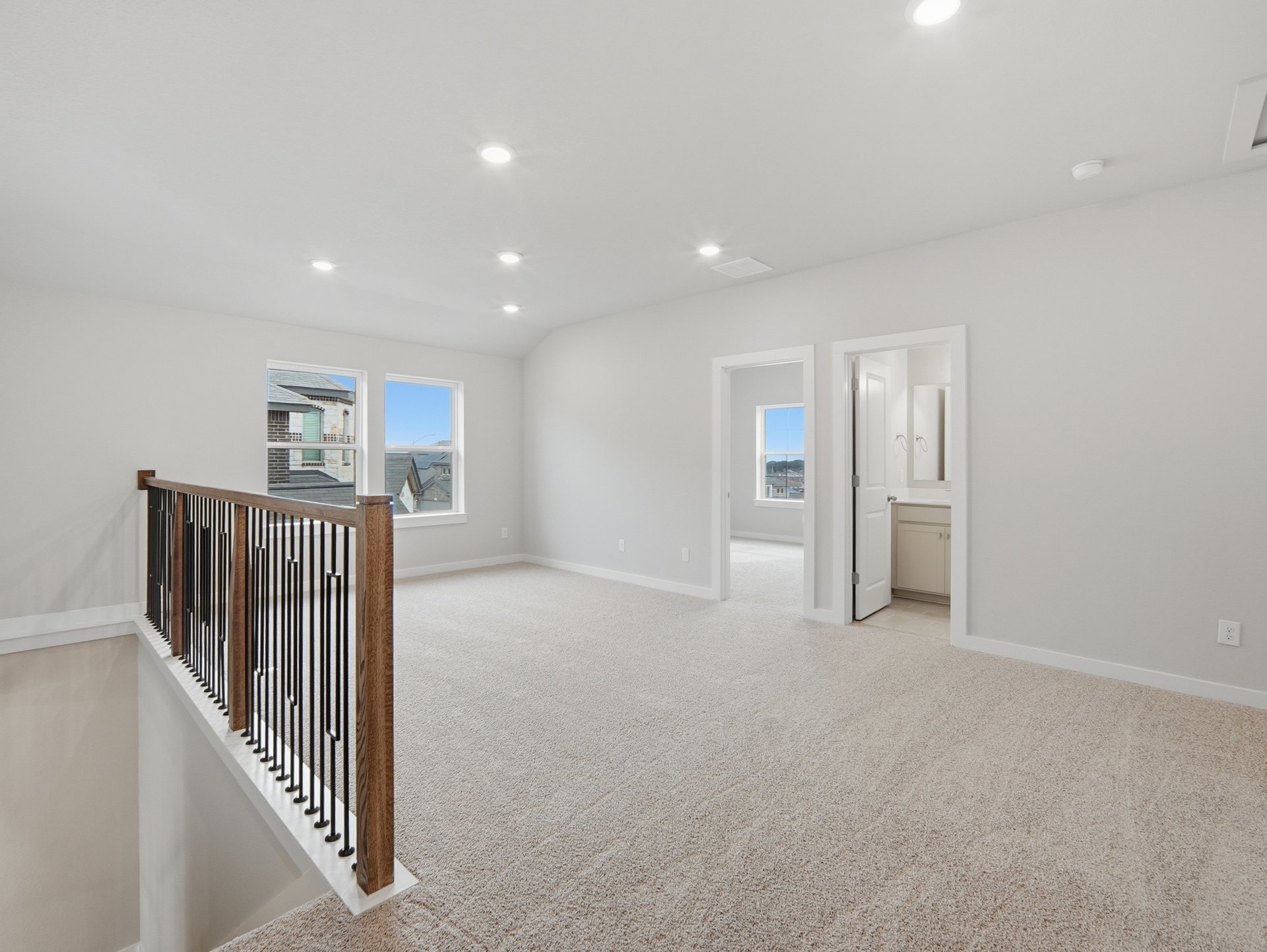 loft with carpet, windows and a sloped ceiling 