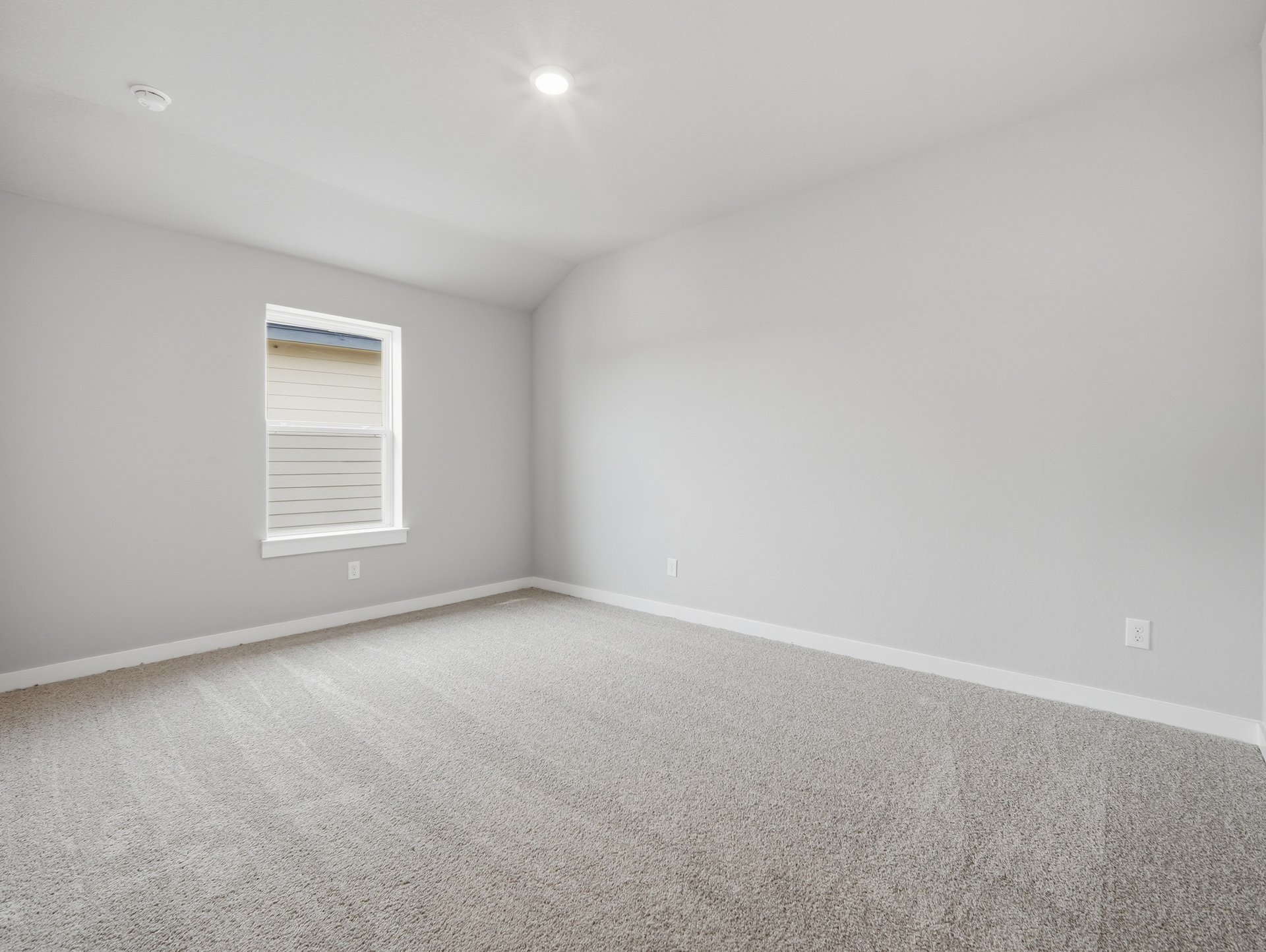 bedroom with carpet, window and sloped ceiling 