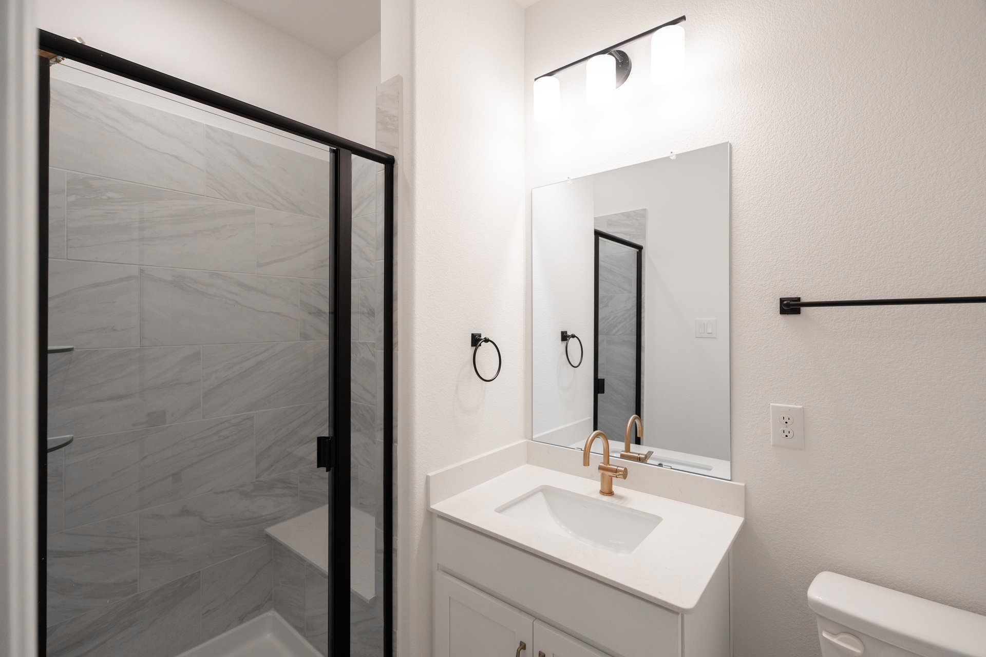 bathroom with walk-in shower and white countertops 