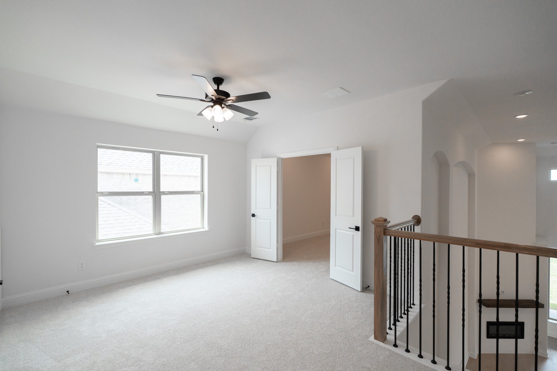 game room with large window and ceiling fan 
