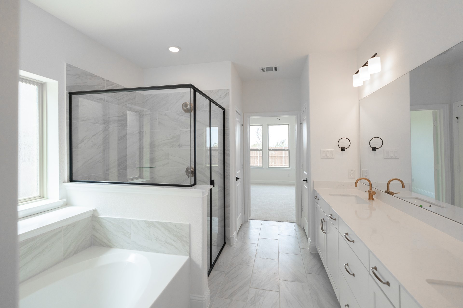 bathroom with large tub and walk-in shower