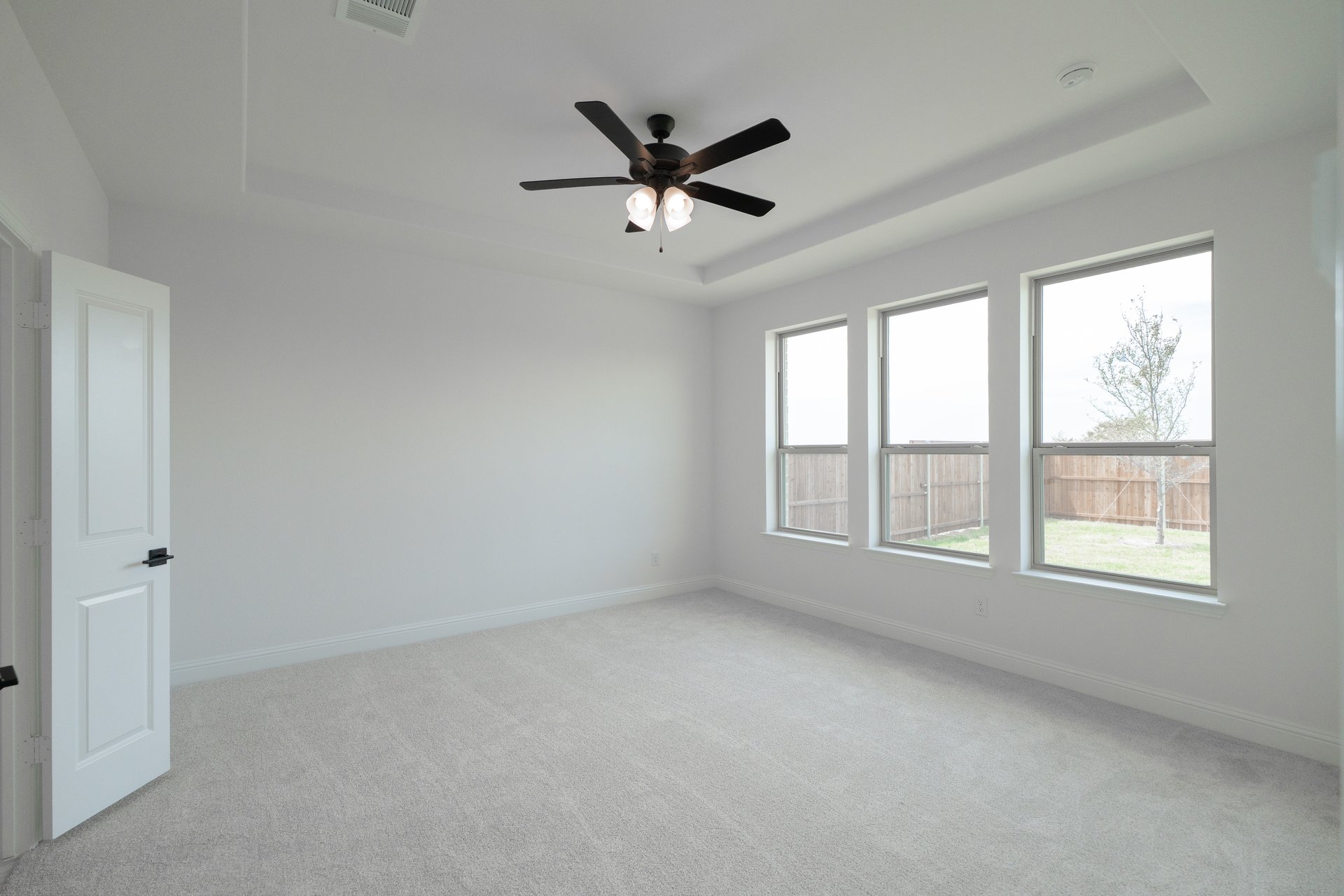 bedroom with carpet and large windows 