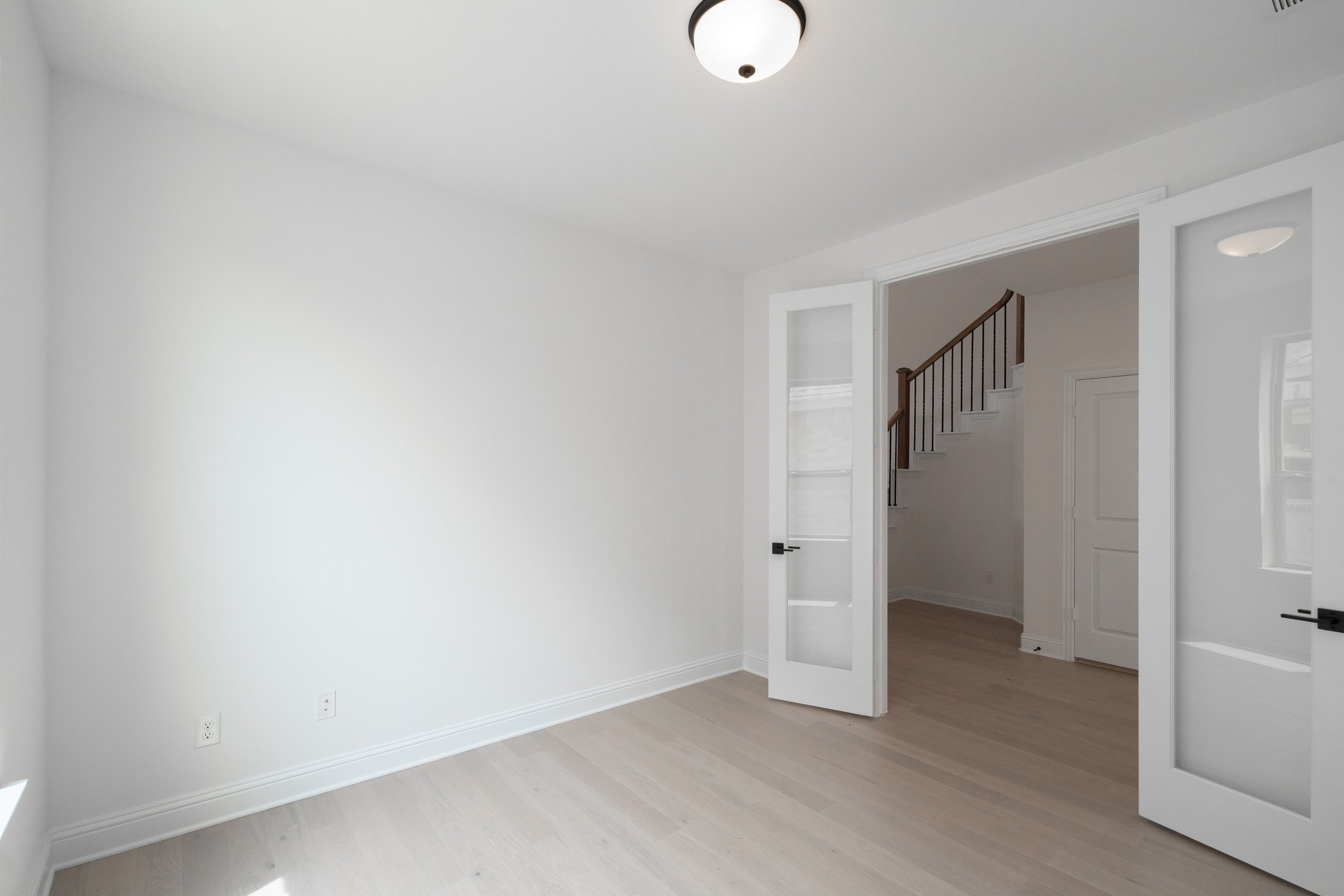 study with wood flooring and french doors 