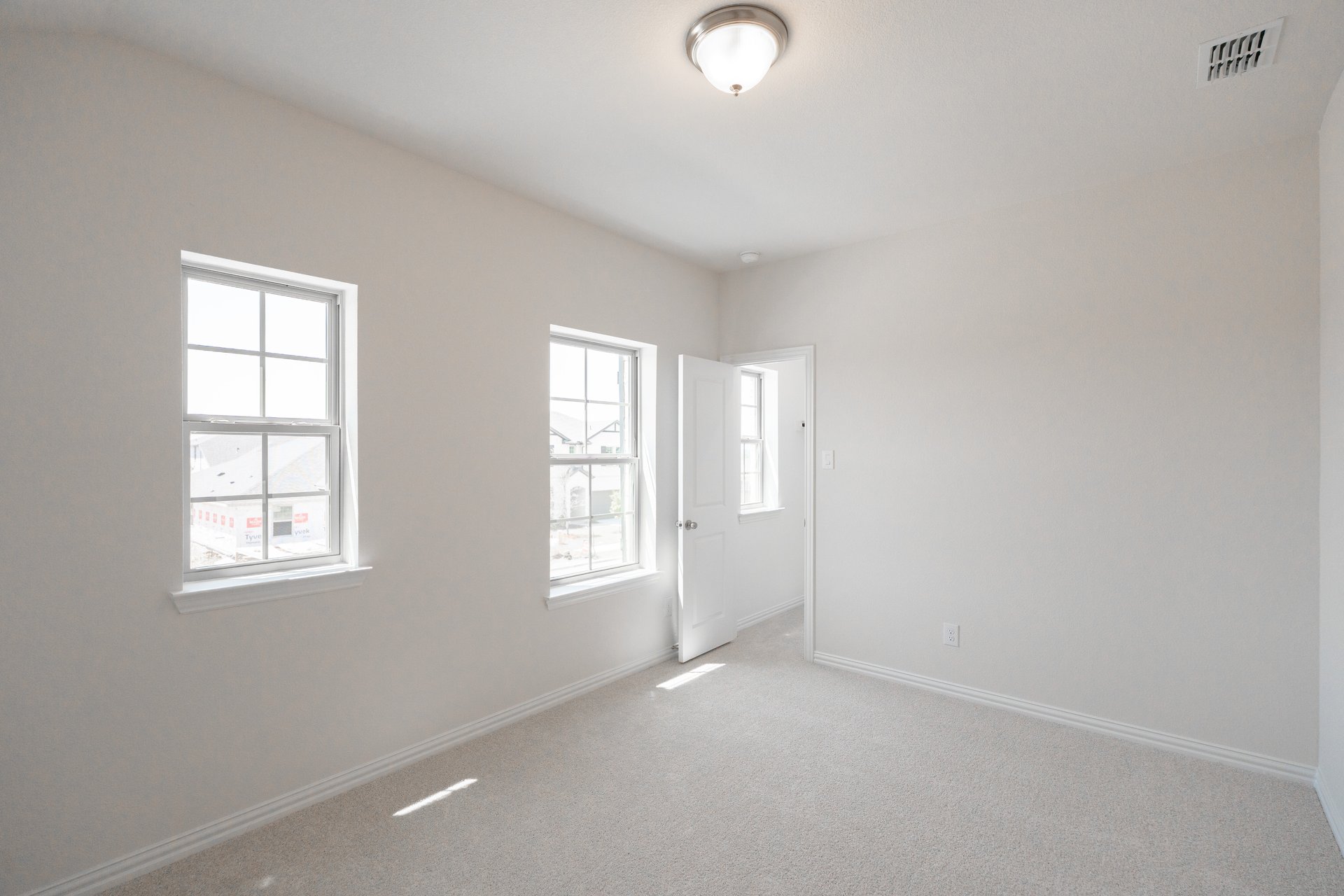 bedroom with carpet and windows