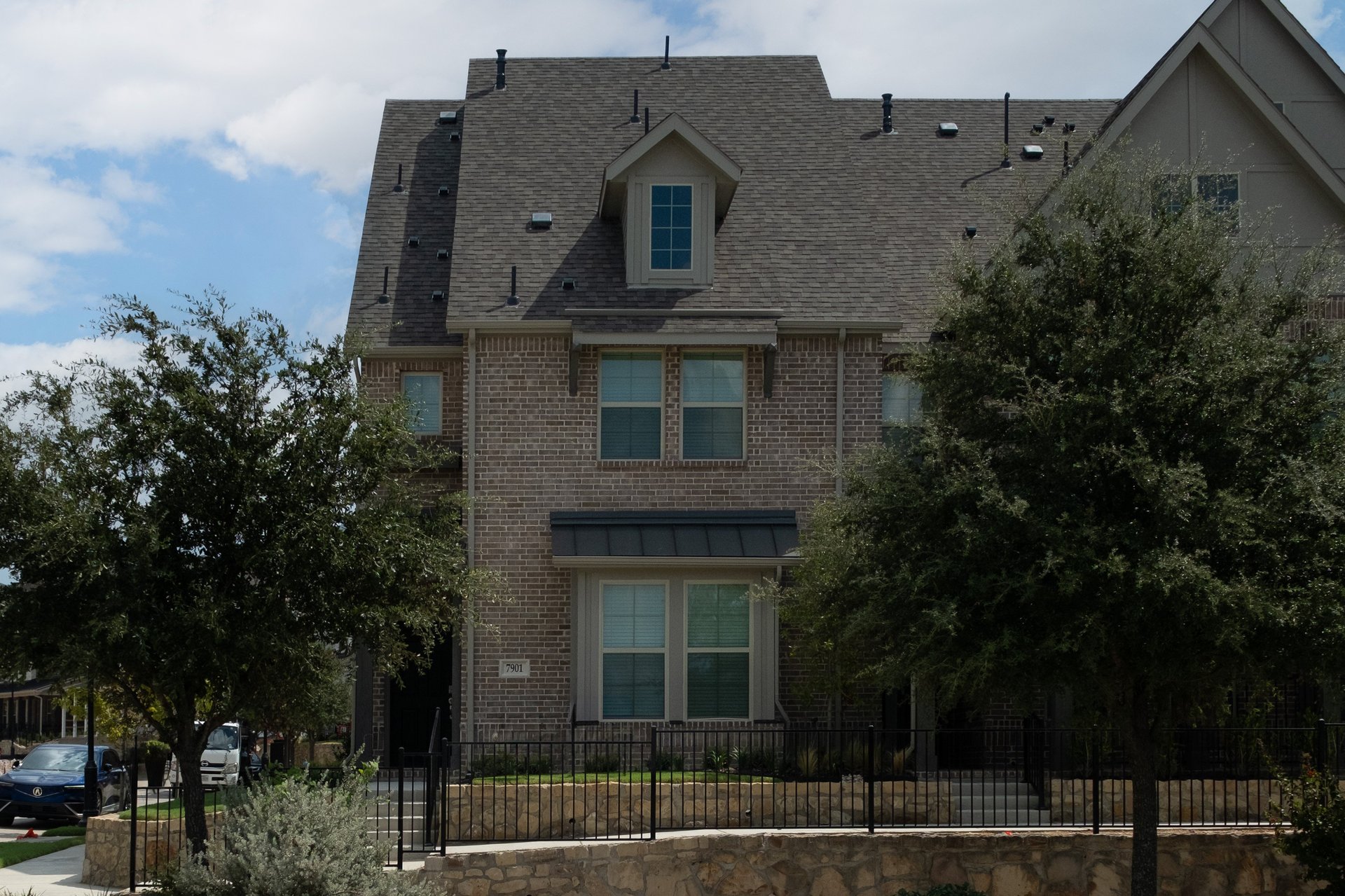 townhome exterior with brick and landscaping