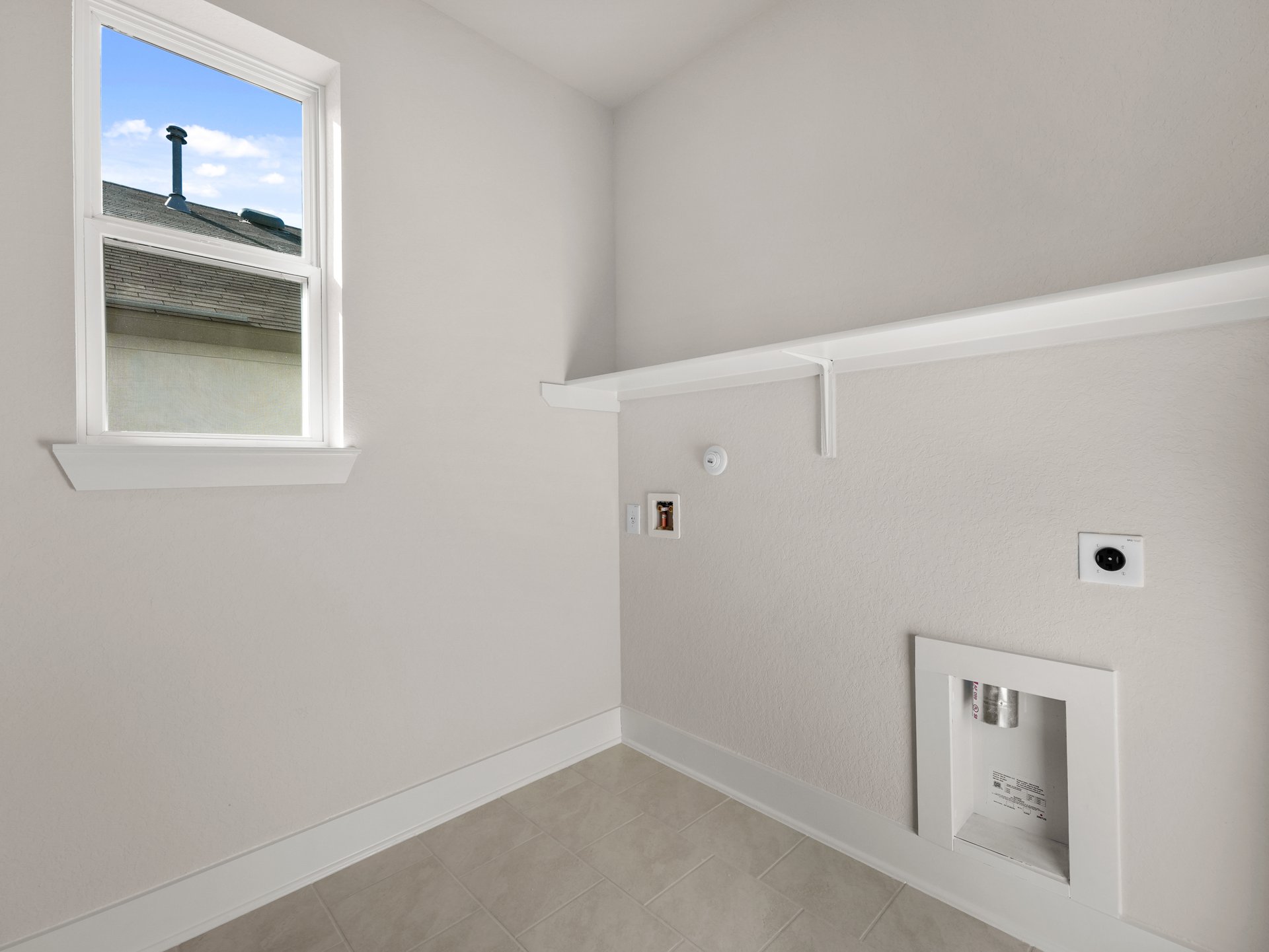 laundry room with window and shelving