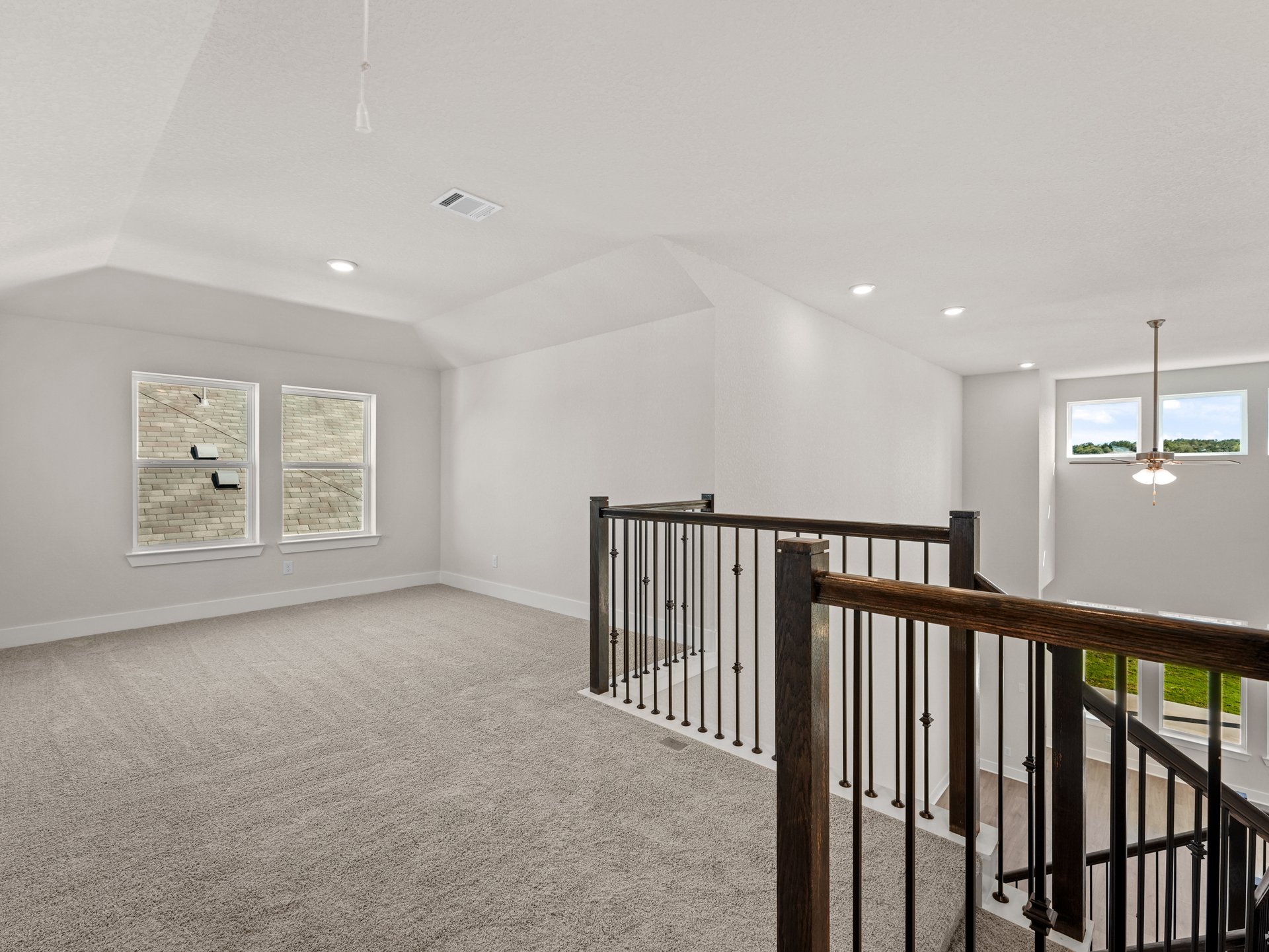 game room with carpet, windows and sloped ceilings