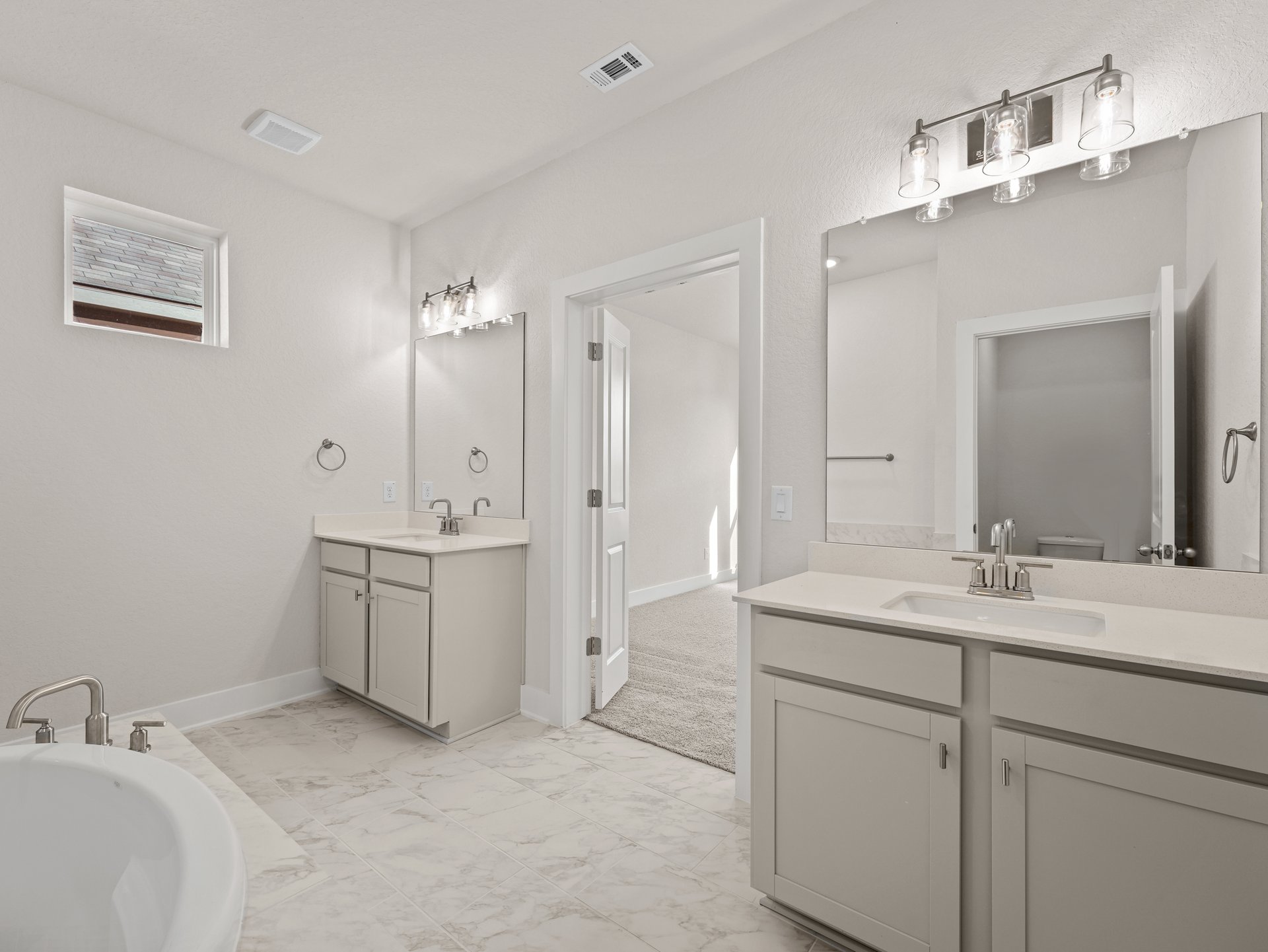 primary bath with dual sinks, soaking tub and walk in shower