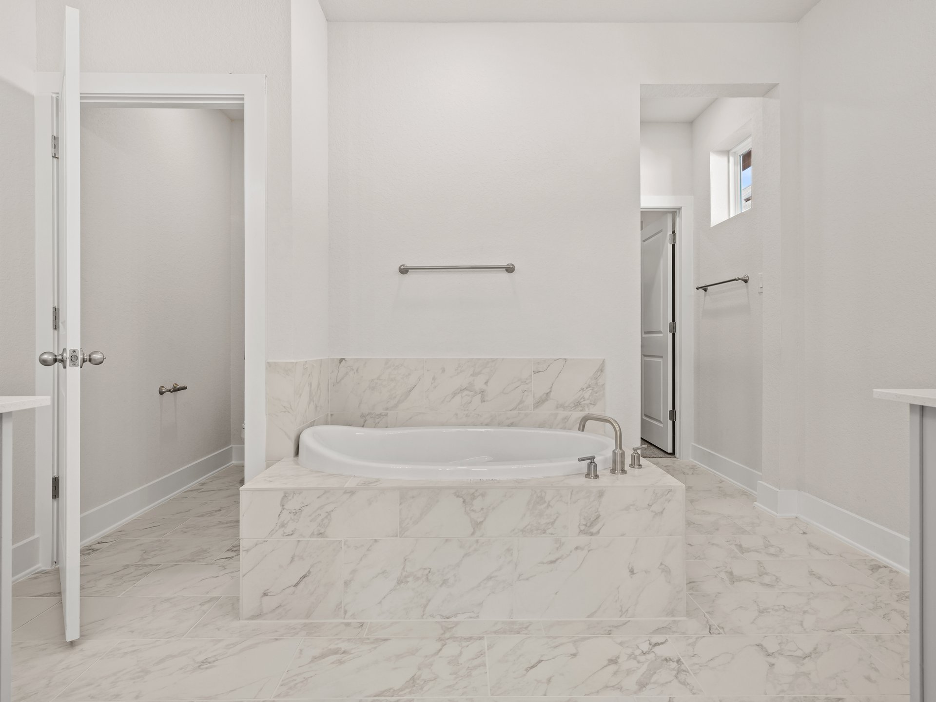 primary bath with dual sinks, soaking tub and walk in shower